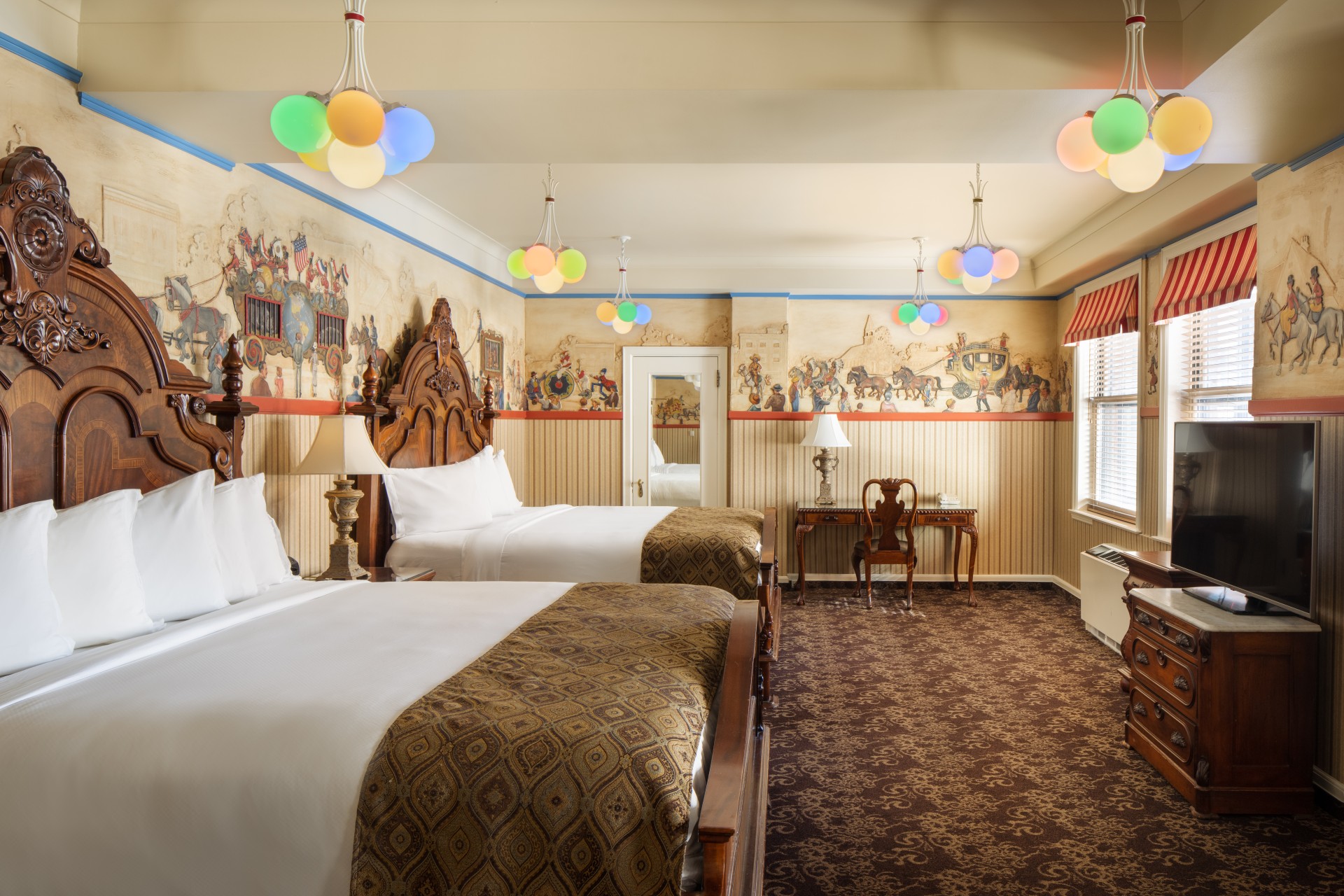 a room with two beds and a mirror