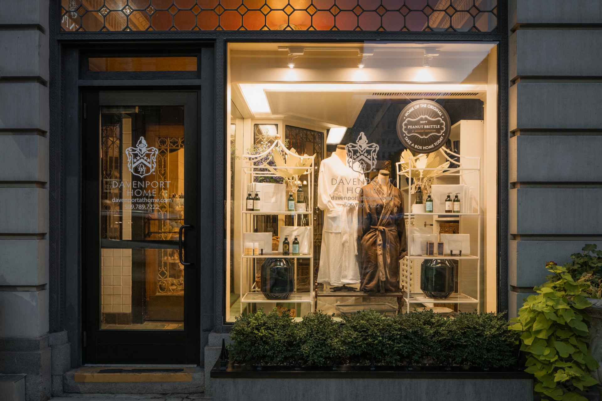 a store front with a mannequin and clothes on display