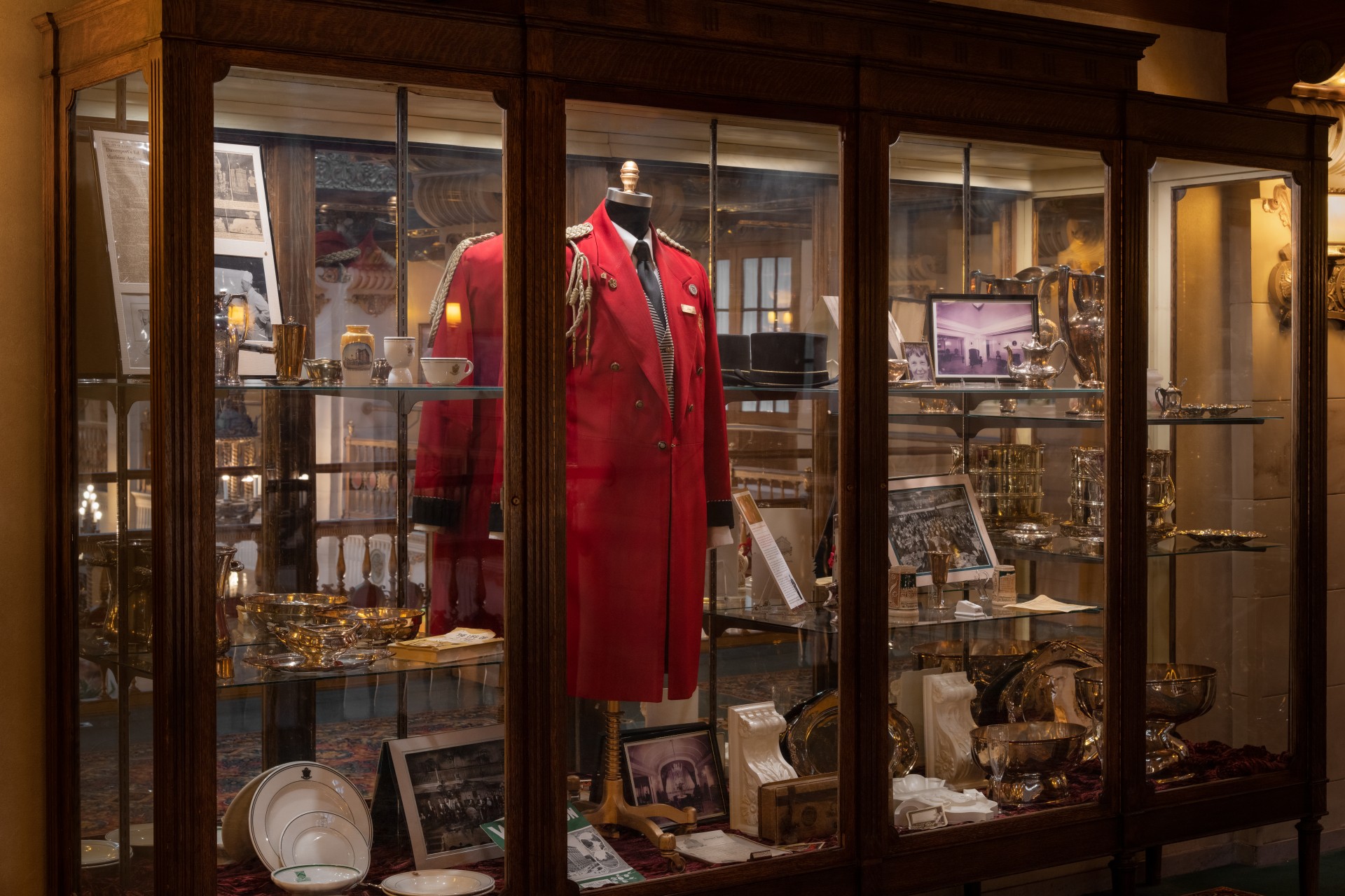a display case with a coat and a coat on it