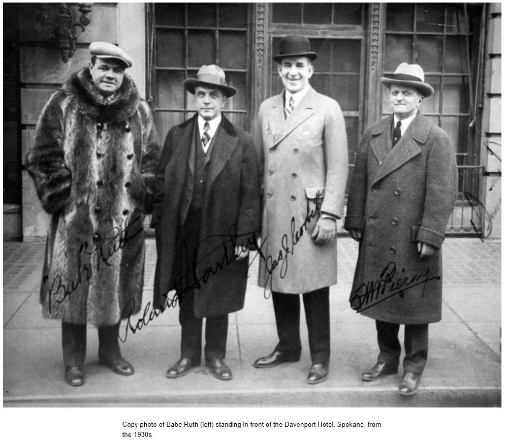 a group of men standing on a sidewalk