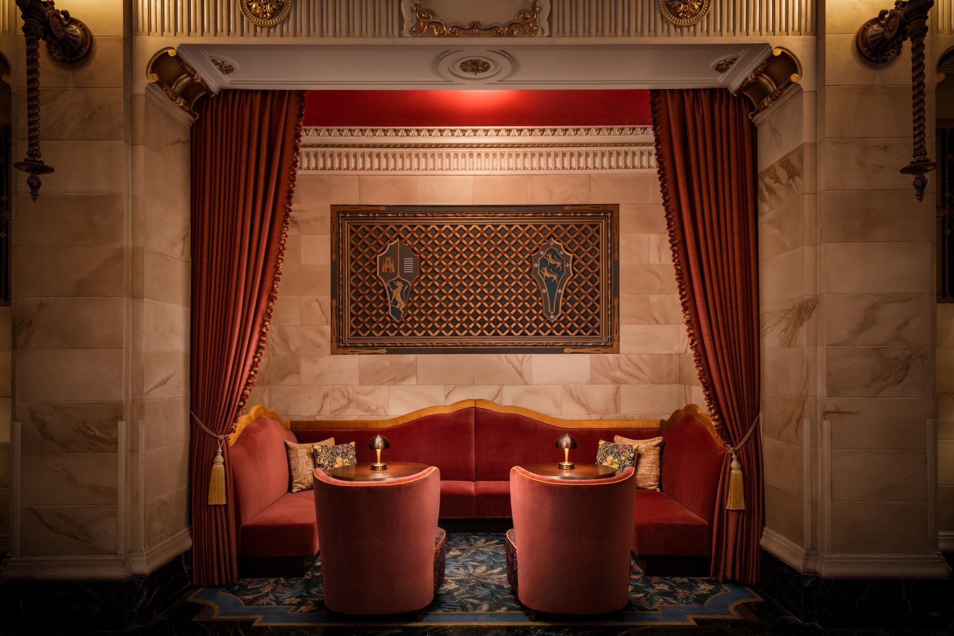 a room with red couches and tables