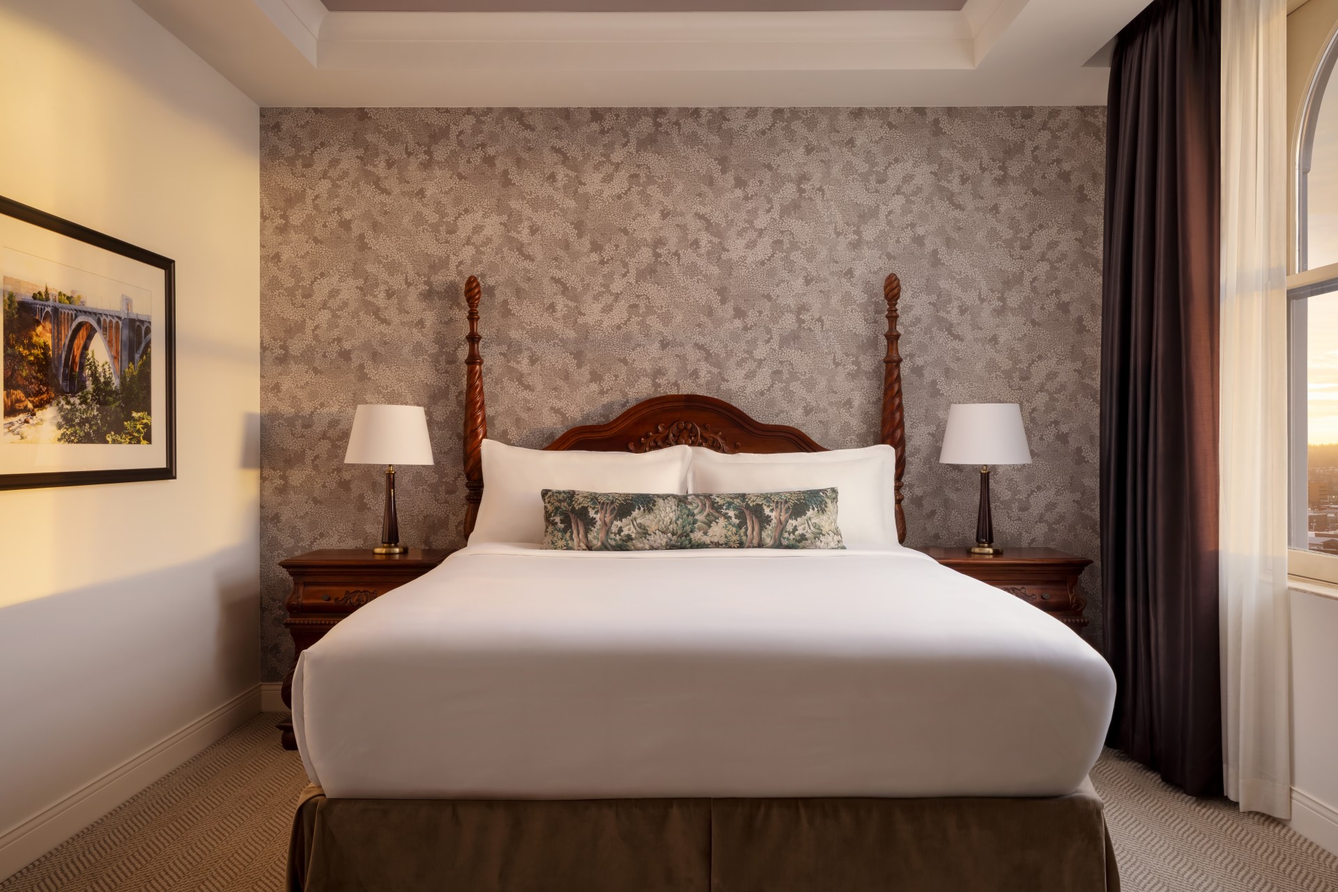 a bed with two lamps in a room