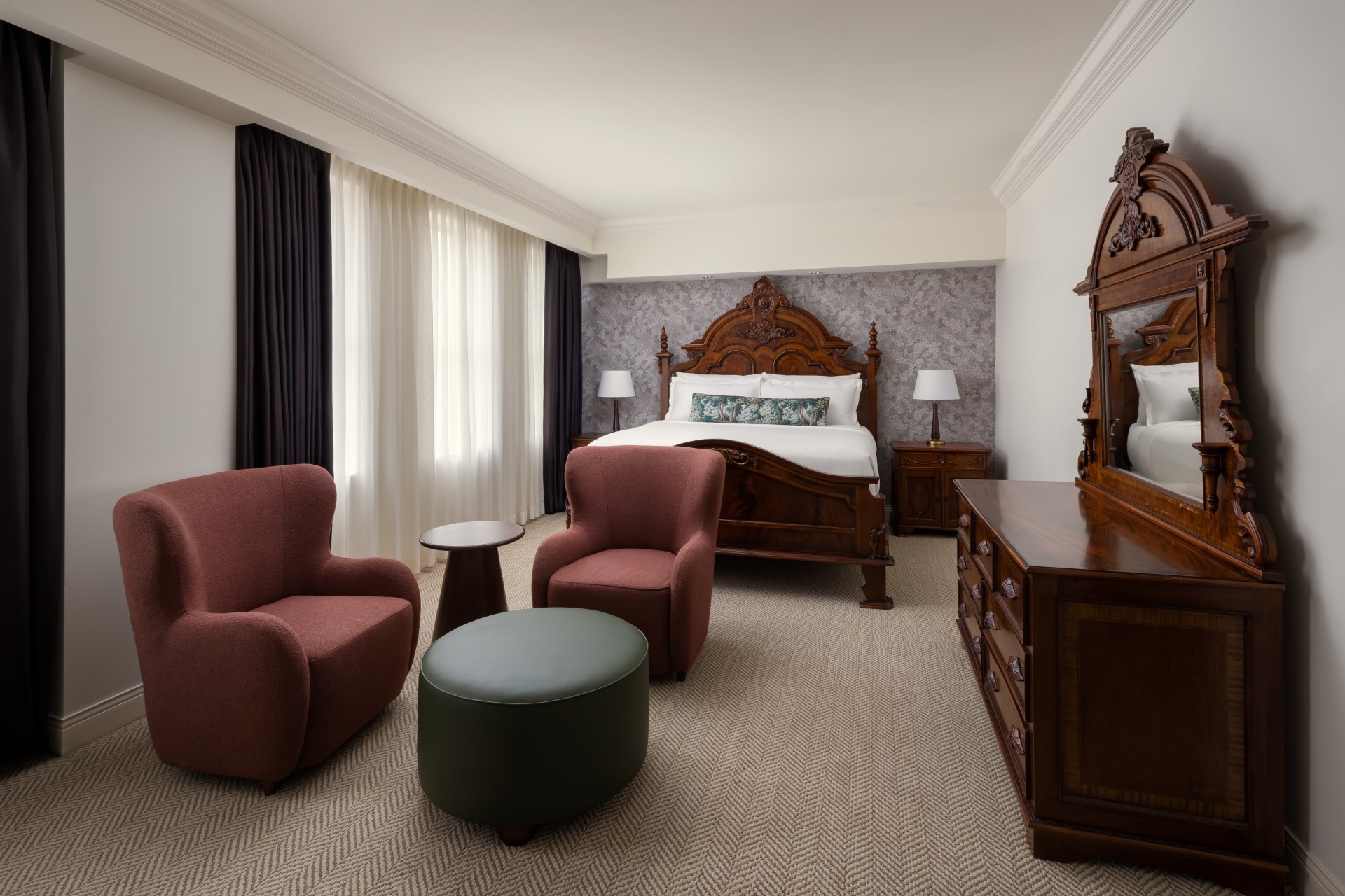 a bedroom with a bed and chairs
