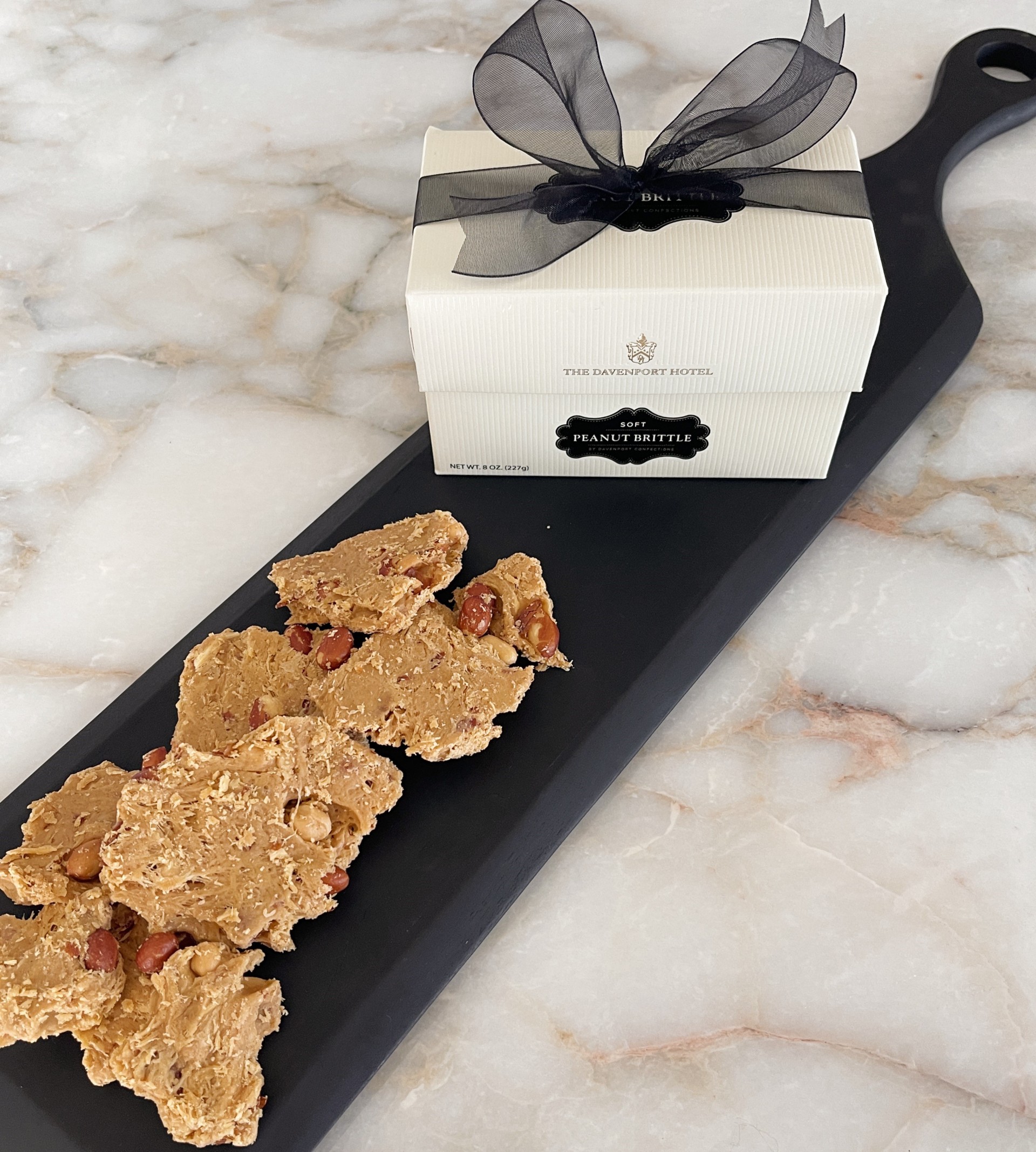 a tray with food on it and a box with a bow