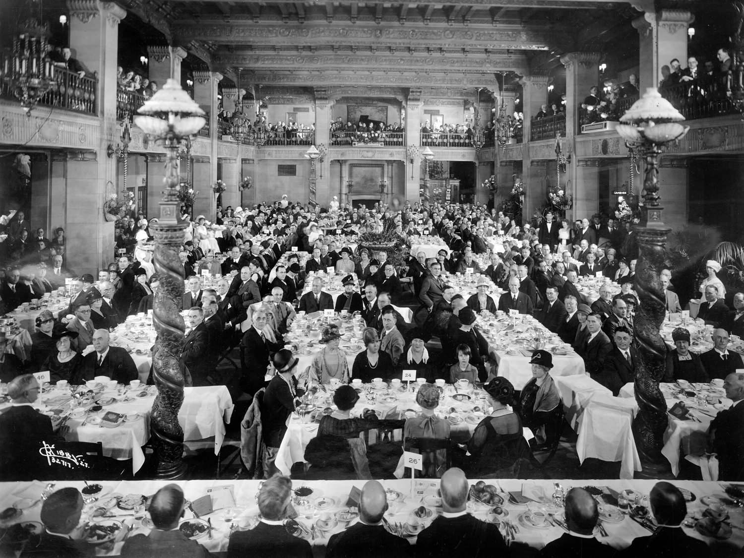 a large group of people sitting at tables in a large room
