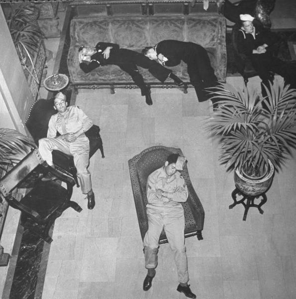 a group of men lying on couches