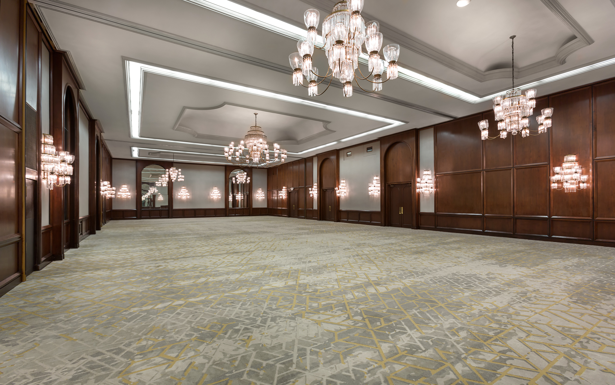 a large room with chandeliers and wood paneling