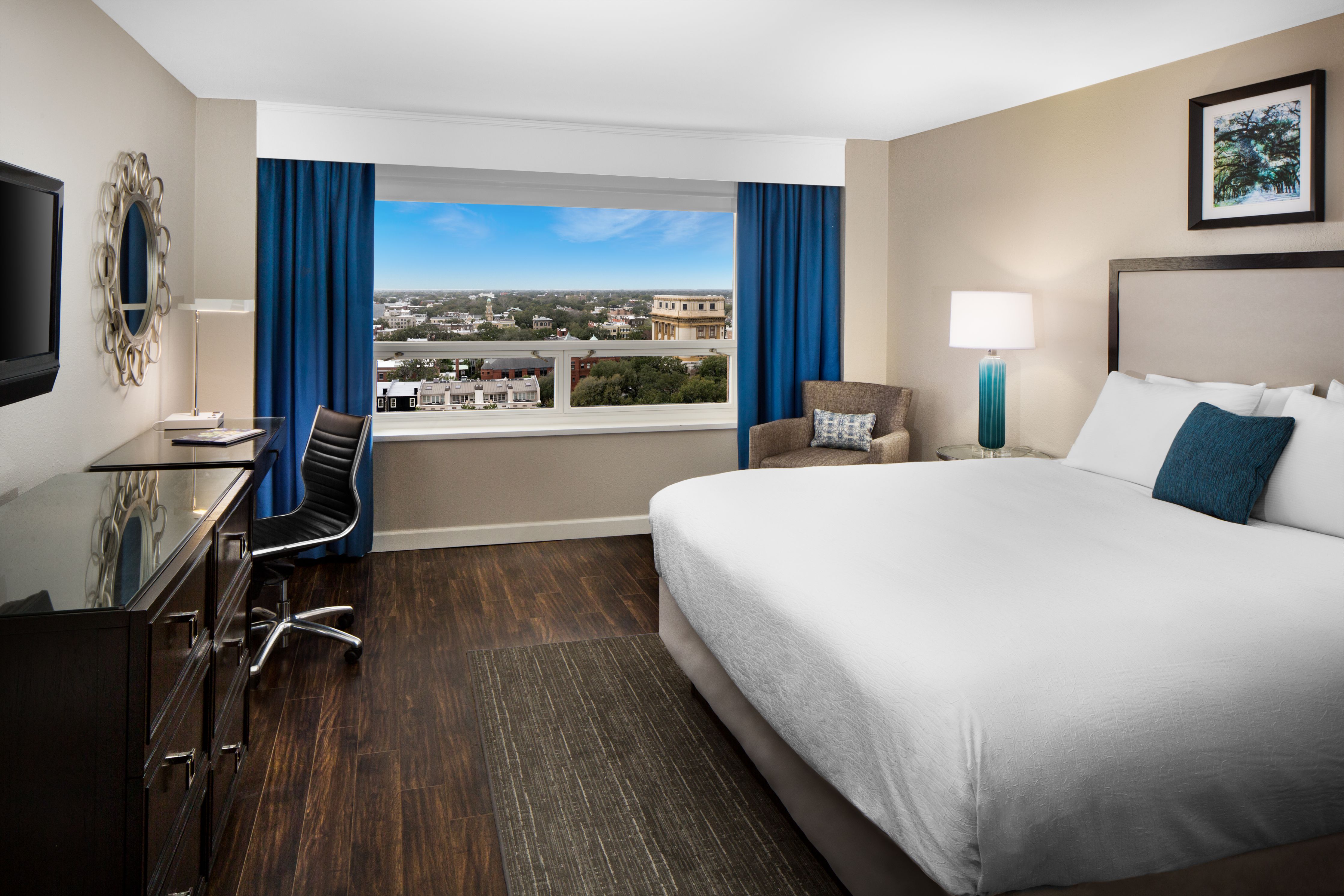 a room with a large bed and a desk
