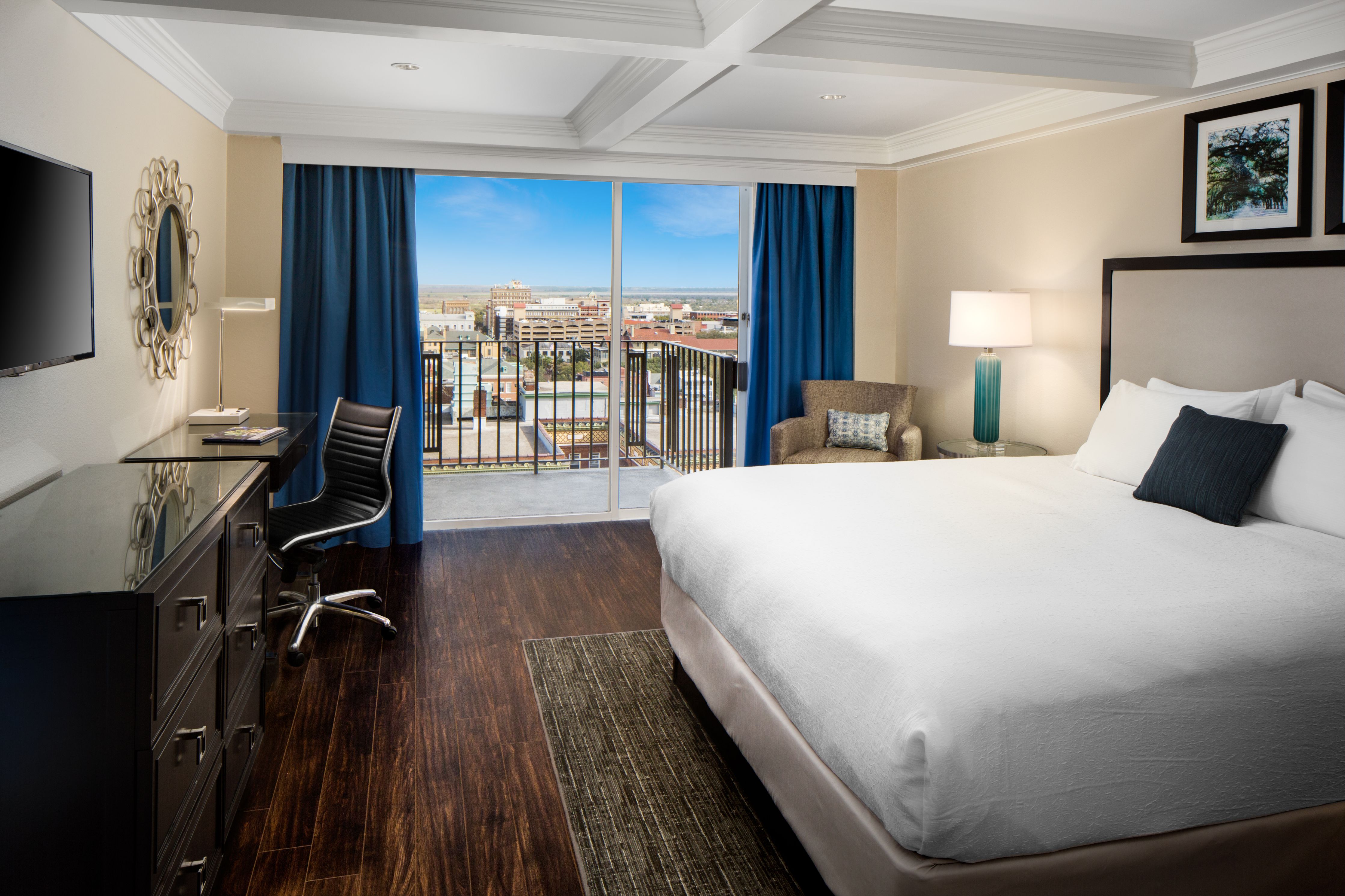 a room with a large bed and a desk