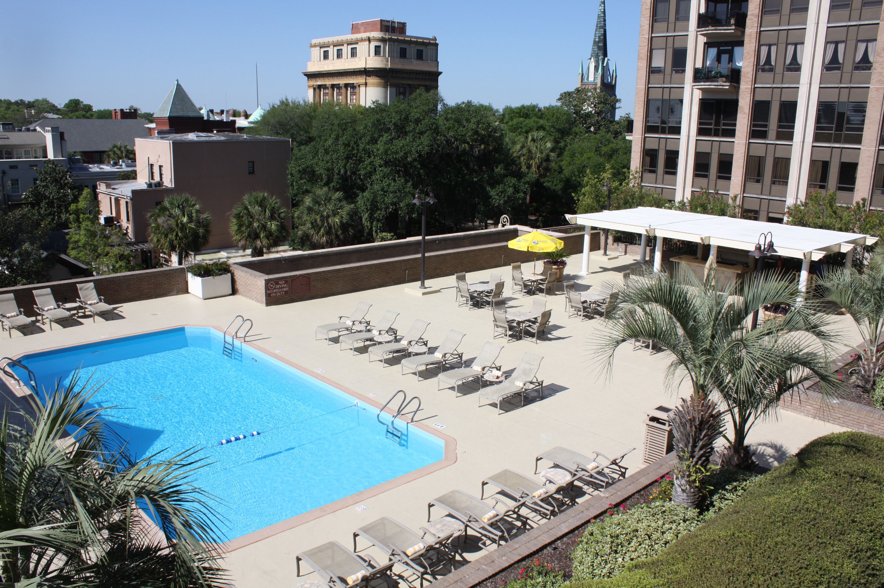 a pool with chairs and umbrellas