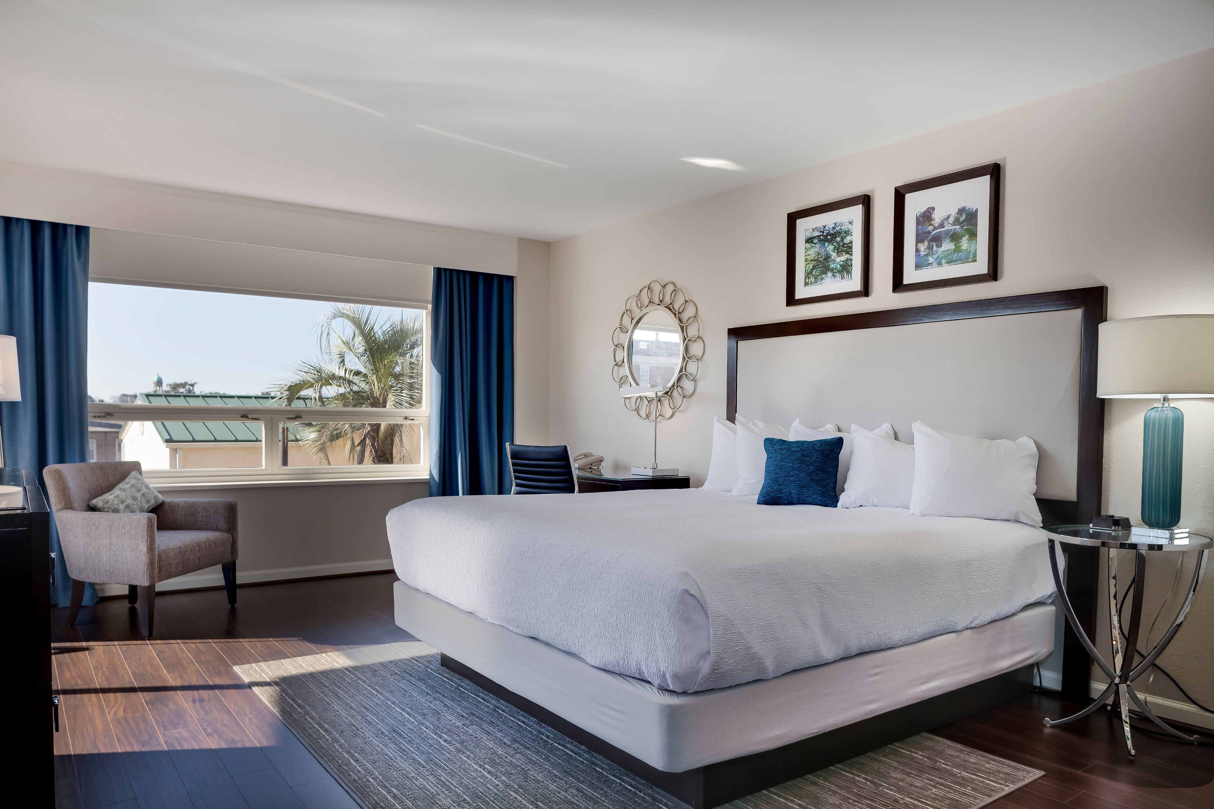 a bedroom with a large bed and a chair