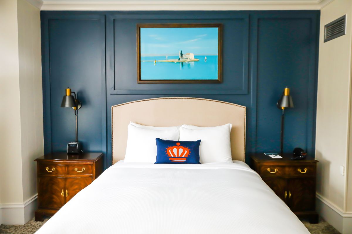 a bed with a white bedding and two nightstands