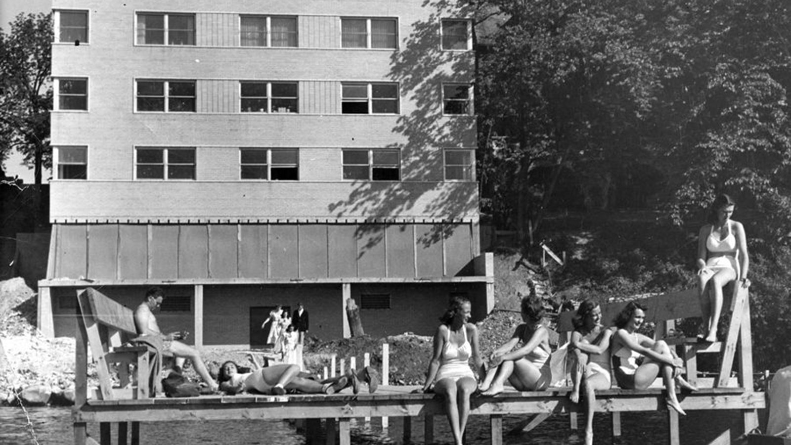 a group of women sitting on a dock
