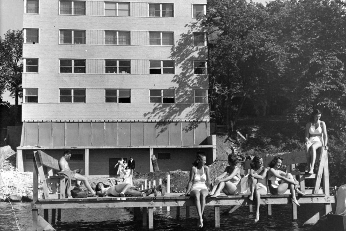 a group of people sitting on a dock