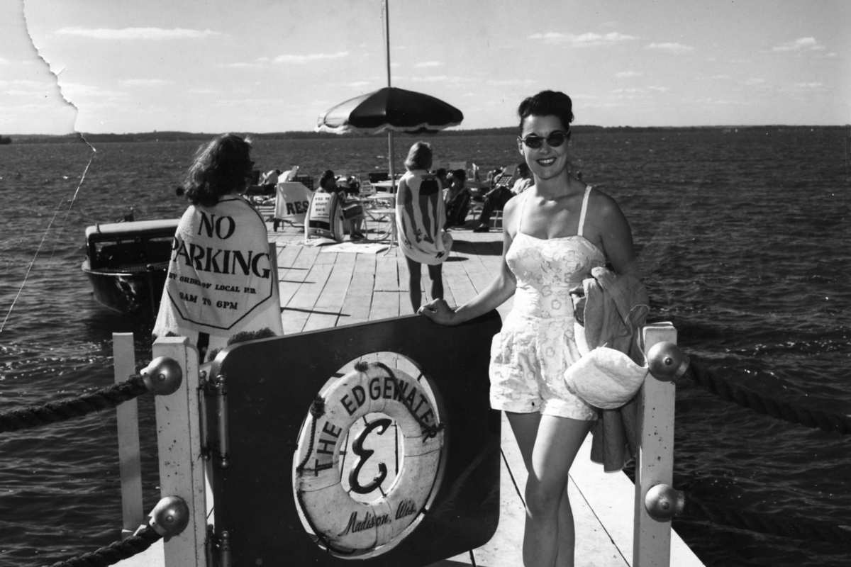a woman standing on a dock