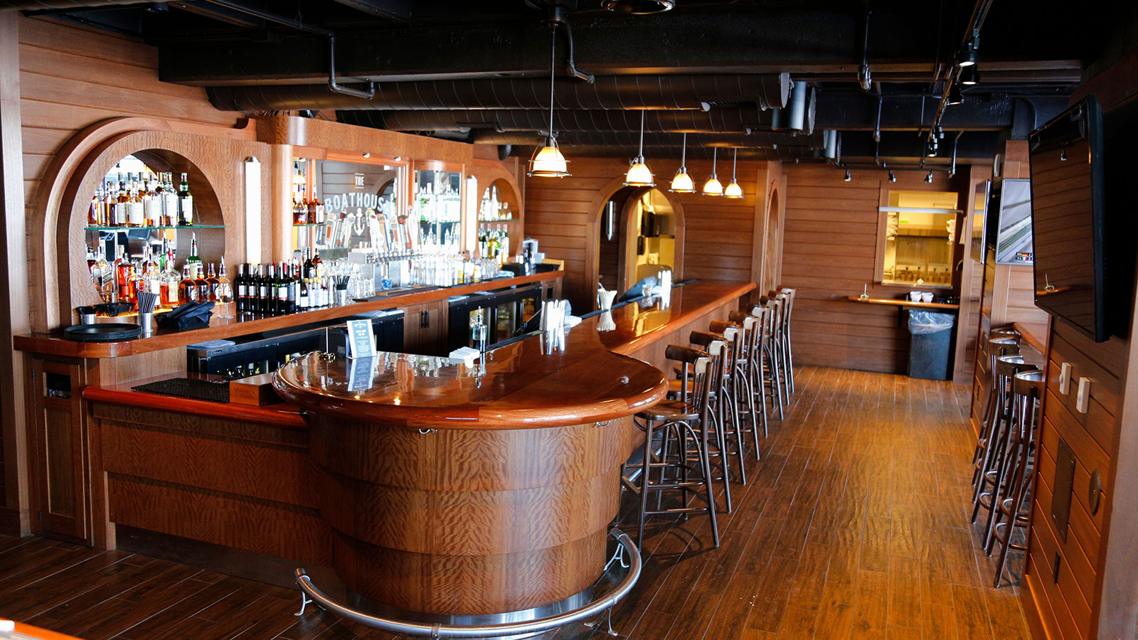 a bar with a wooden counter and stools