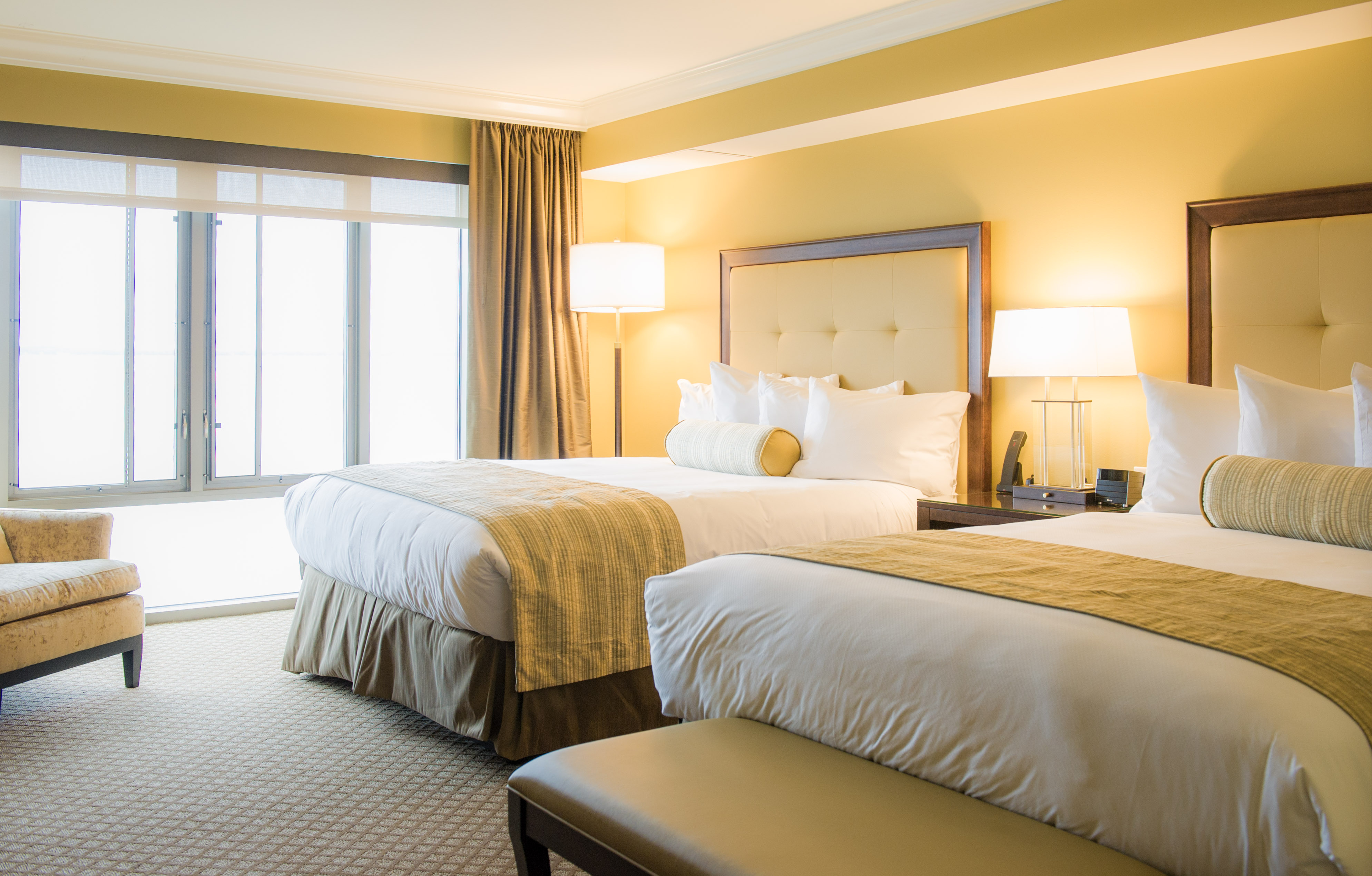 a room with two beds and a large window