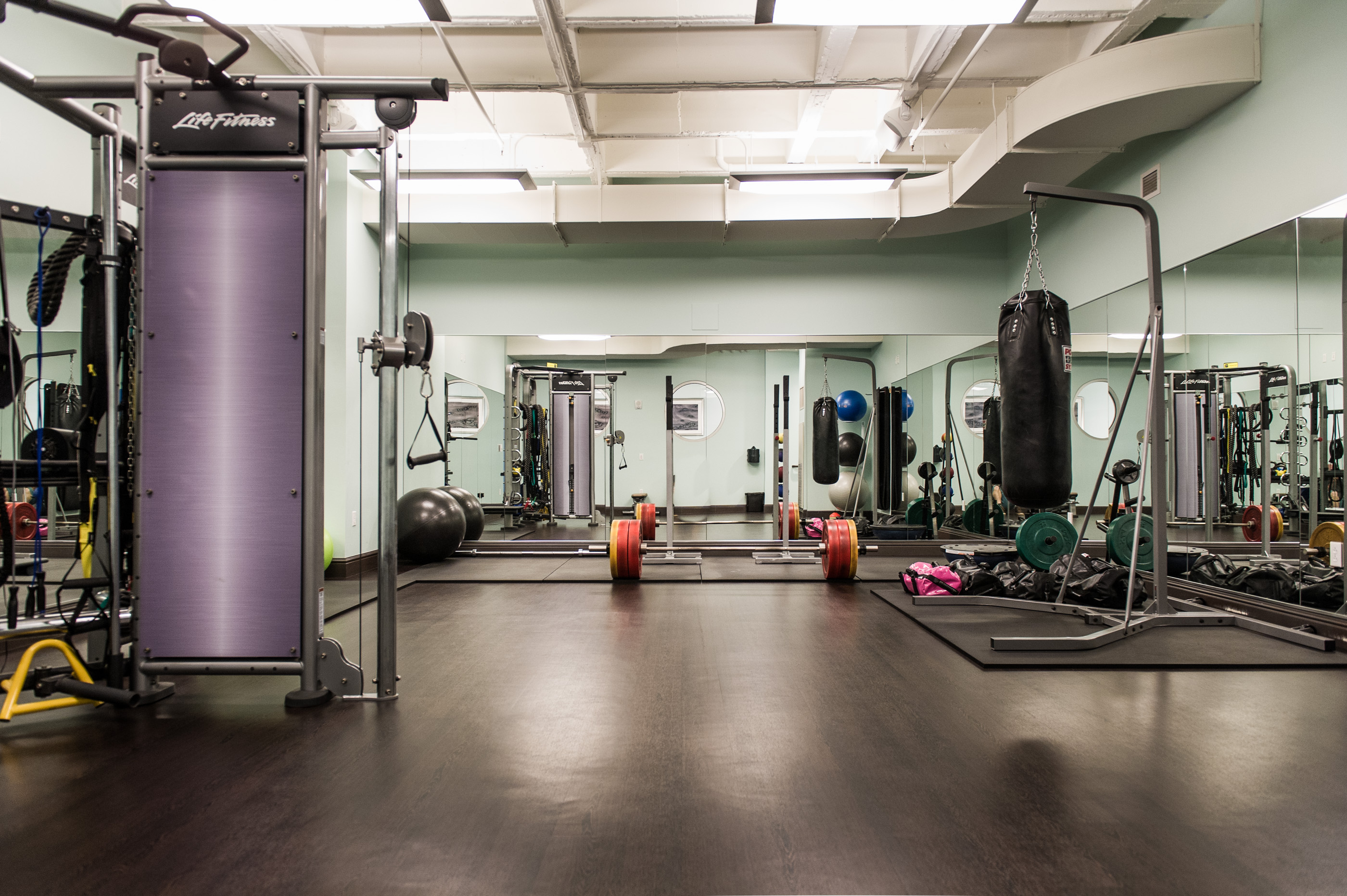 a gym with a large room with a large punching bag and exercise equipment