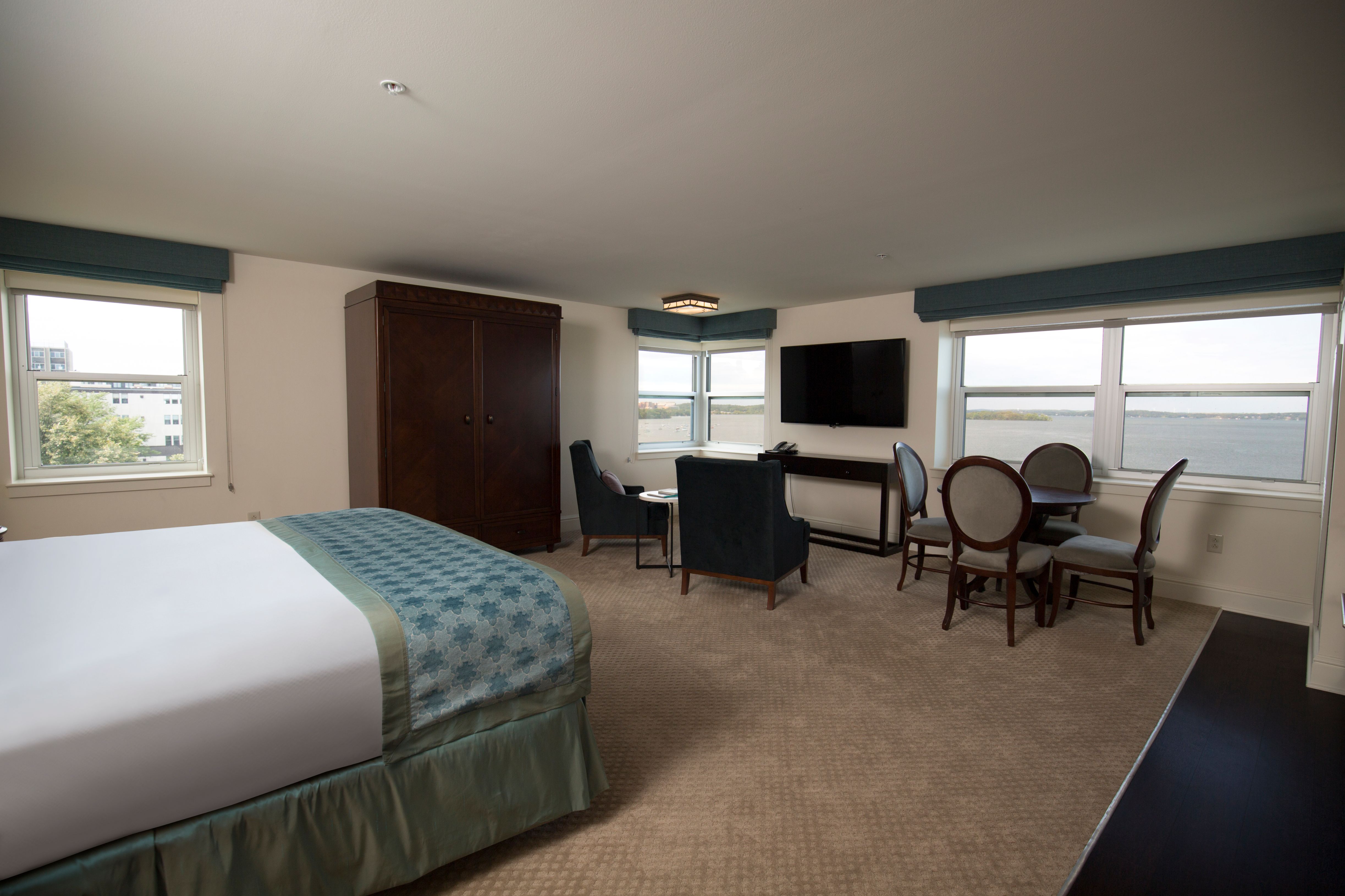 a room with a bed and a television