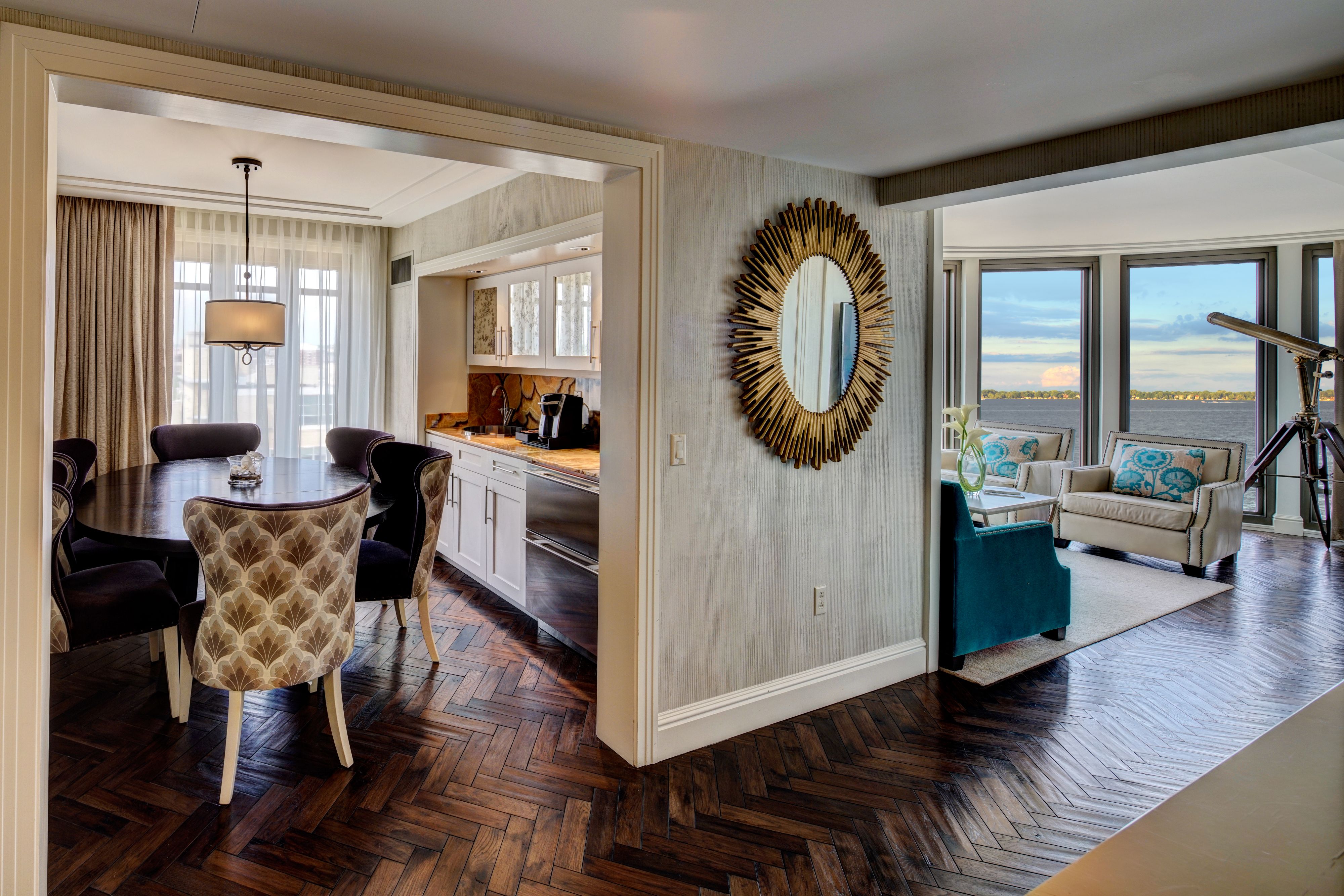 a room with a dining table and a mirror