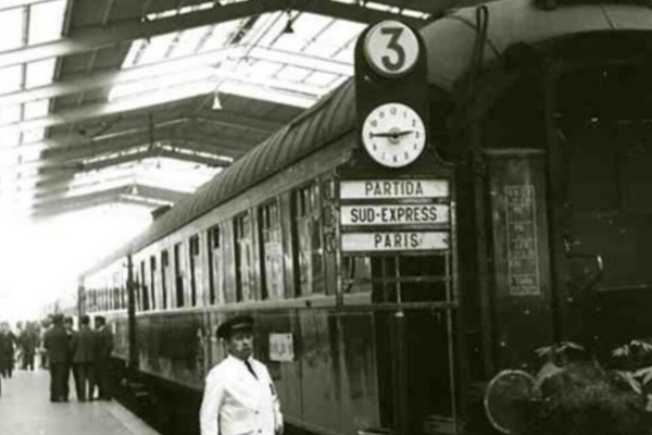 a man standing next to a train