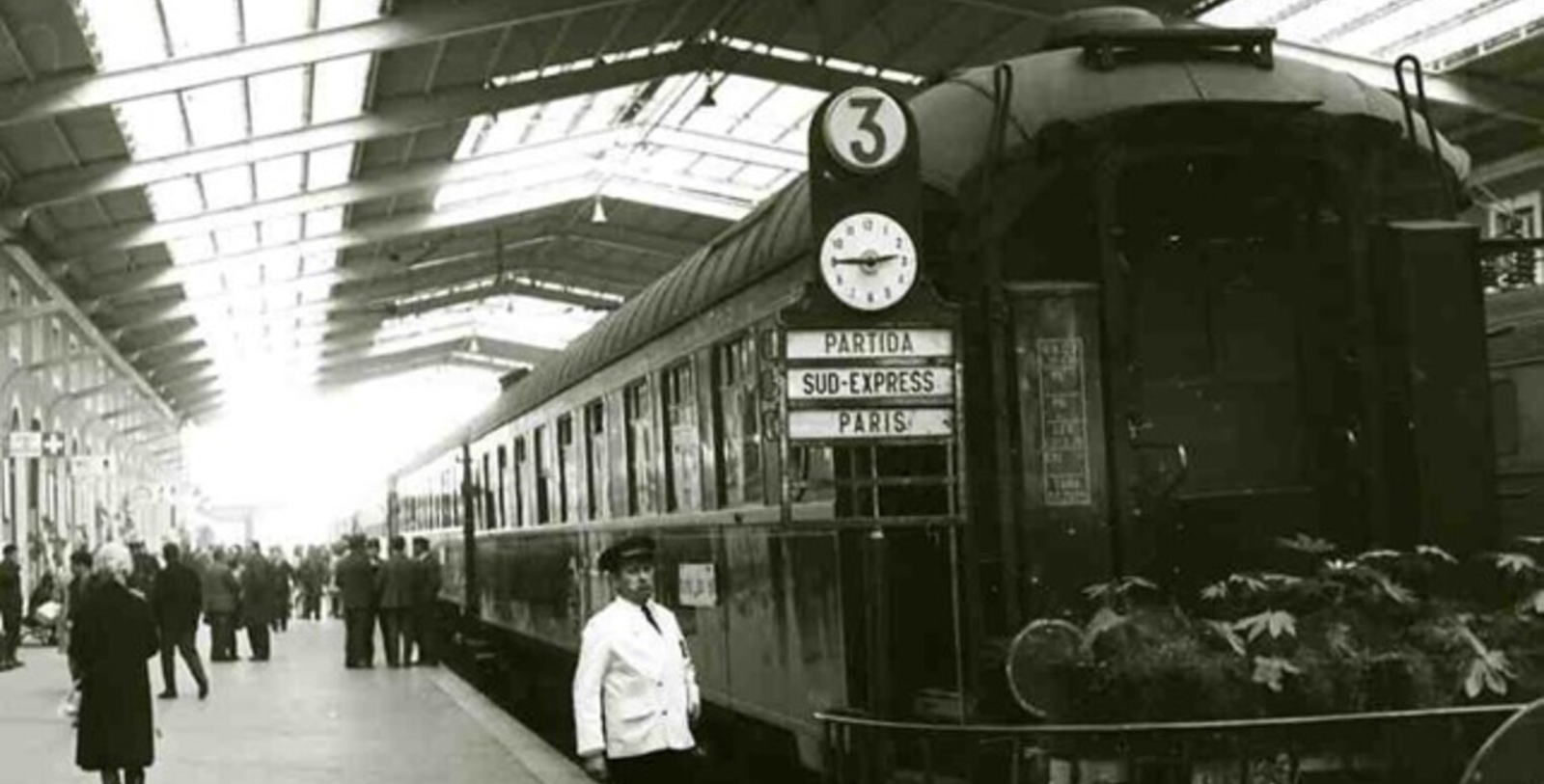 a man standing next to a train