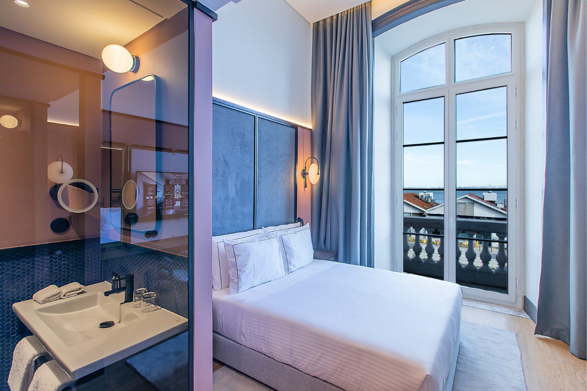 a bedroom with a large window and a bed