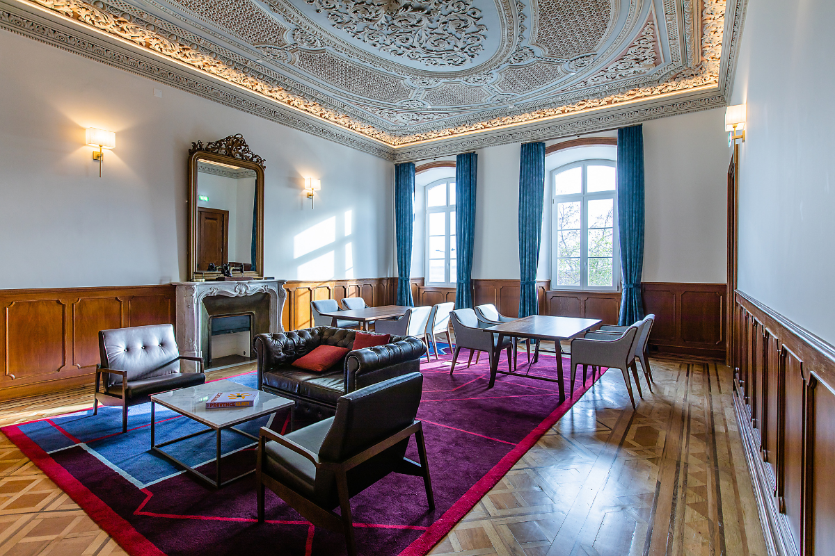 a room with a fireplace and chairs