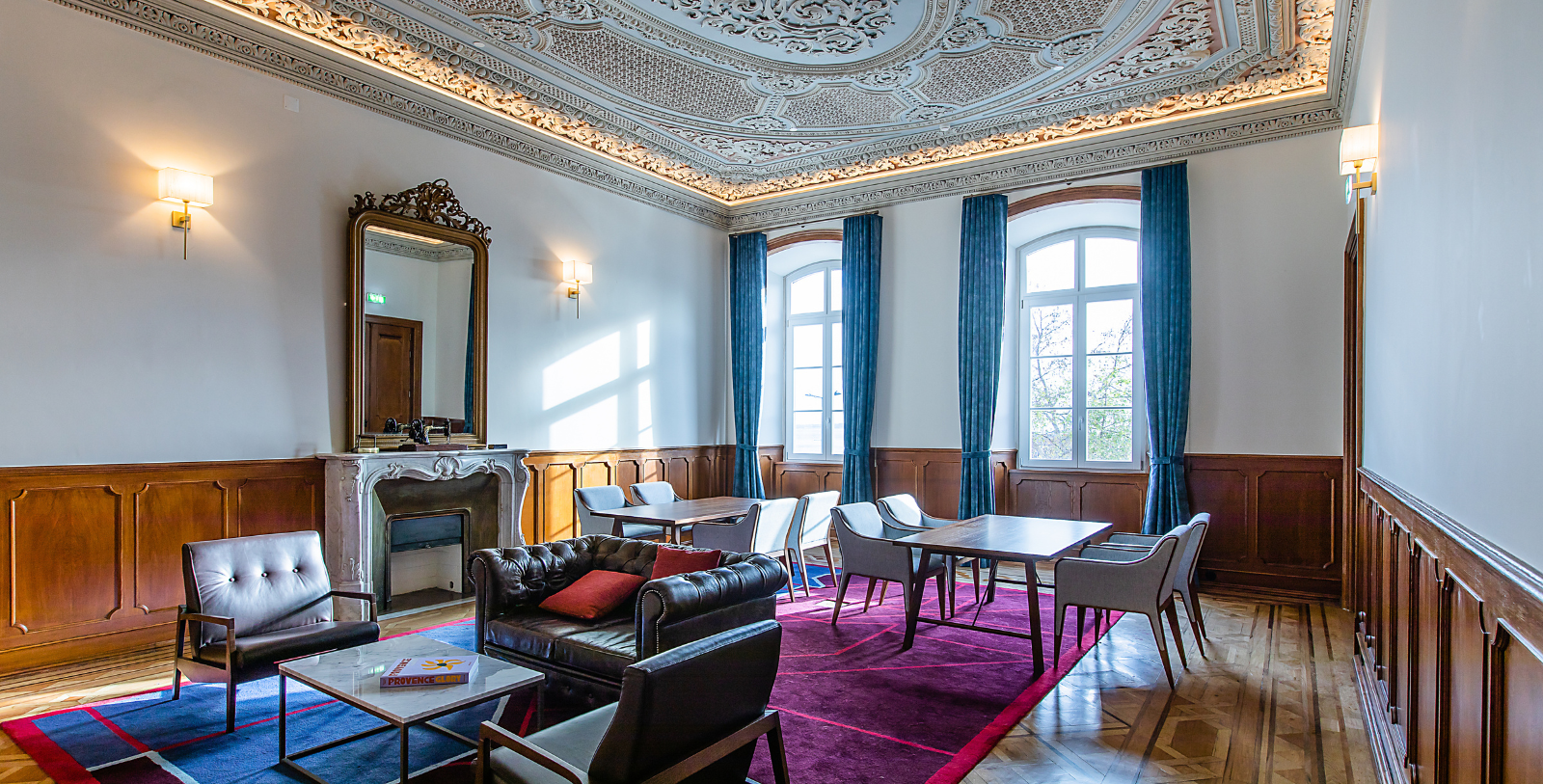 a room with a fireplace and chairs