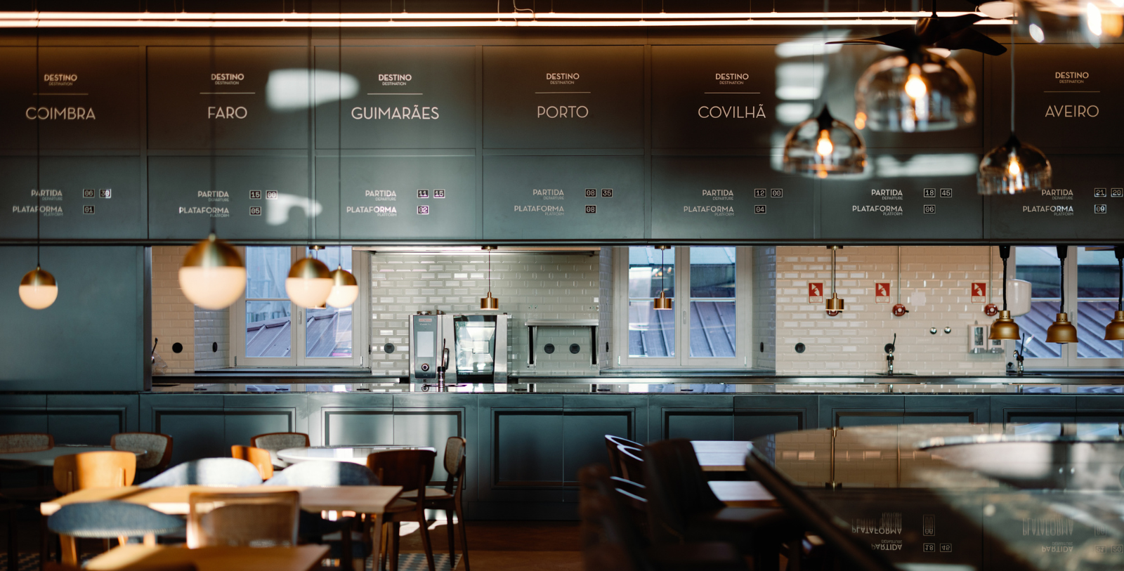 a kitchen with a large counter and chairs