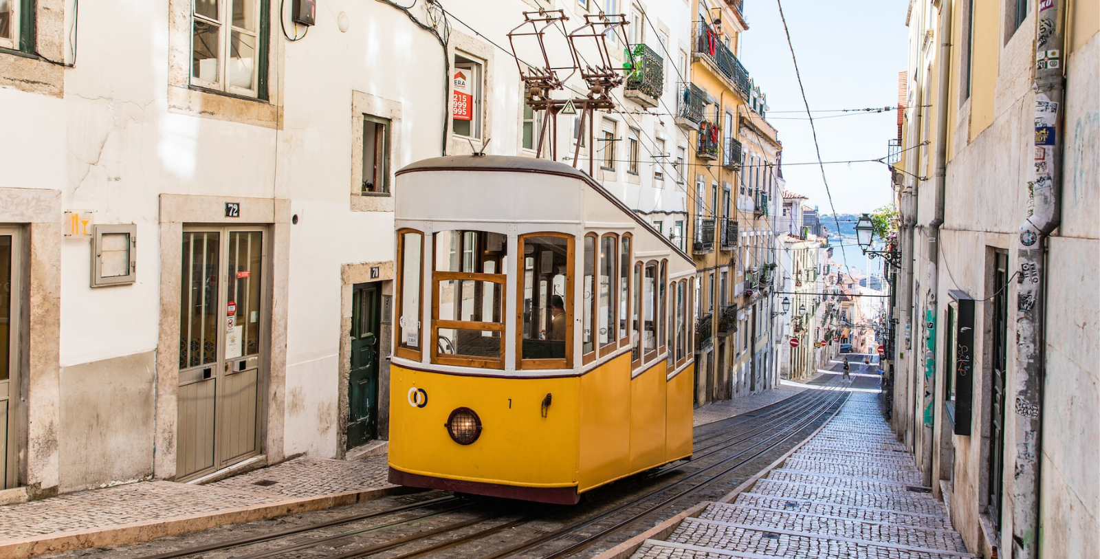a yellow trolley on a street