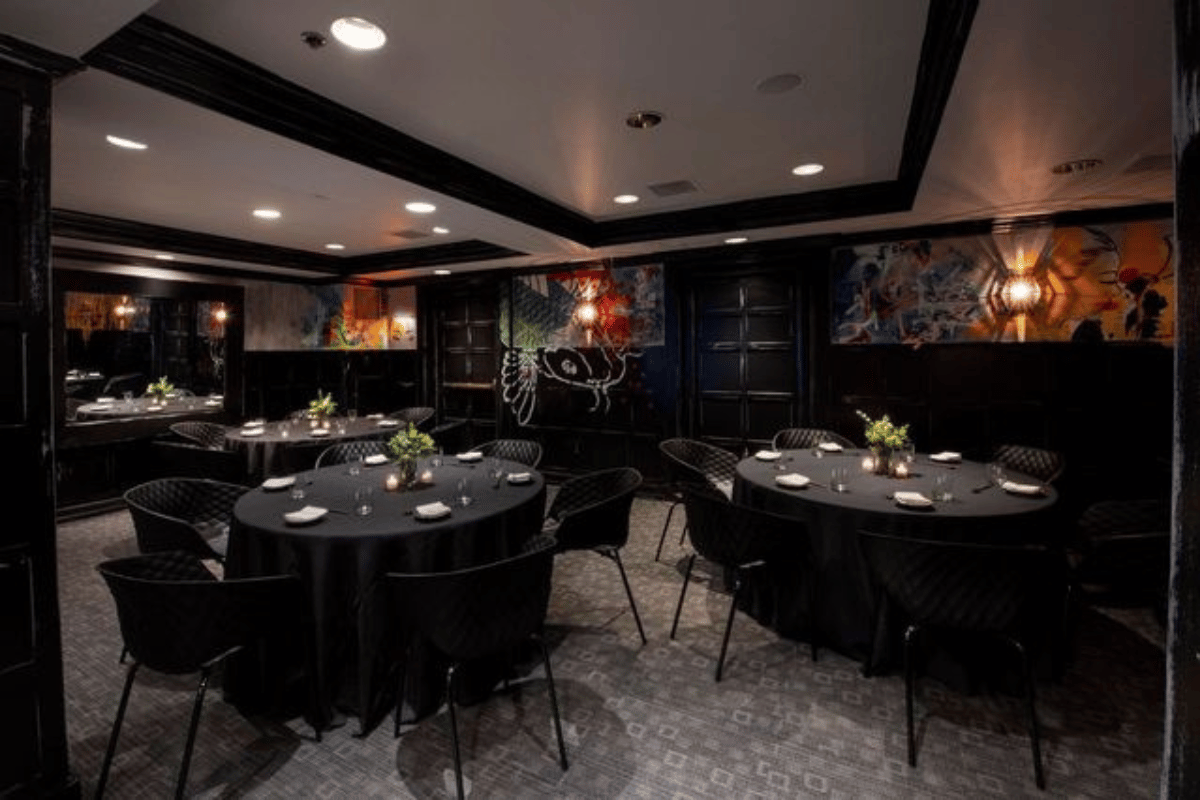 a room with black tables and chairs
