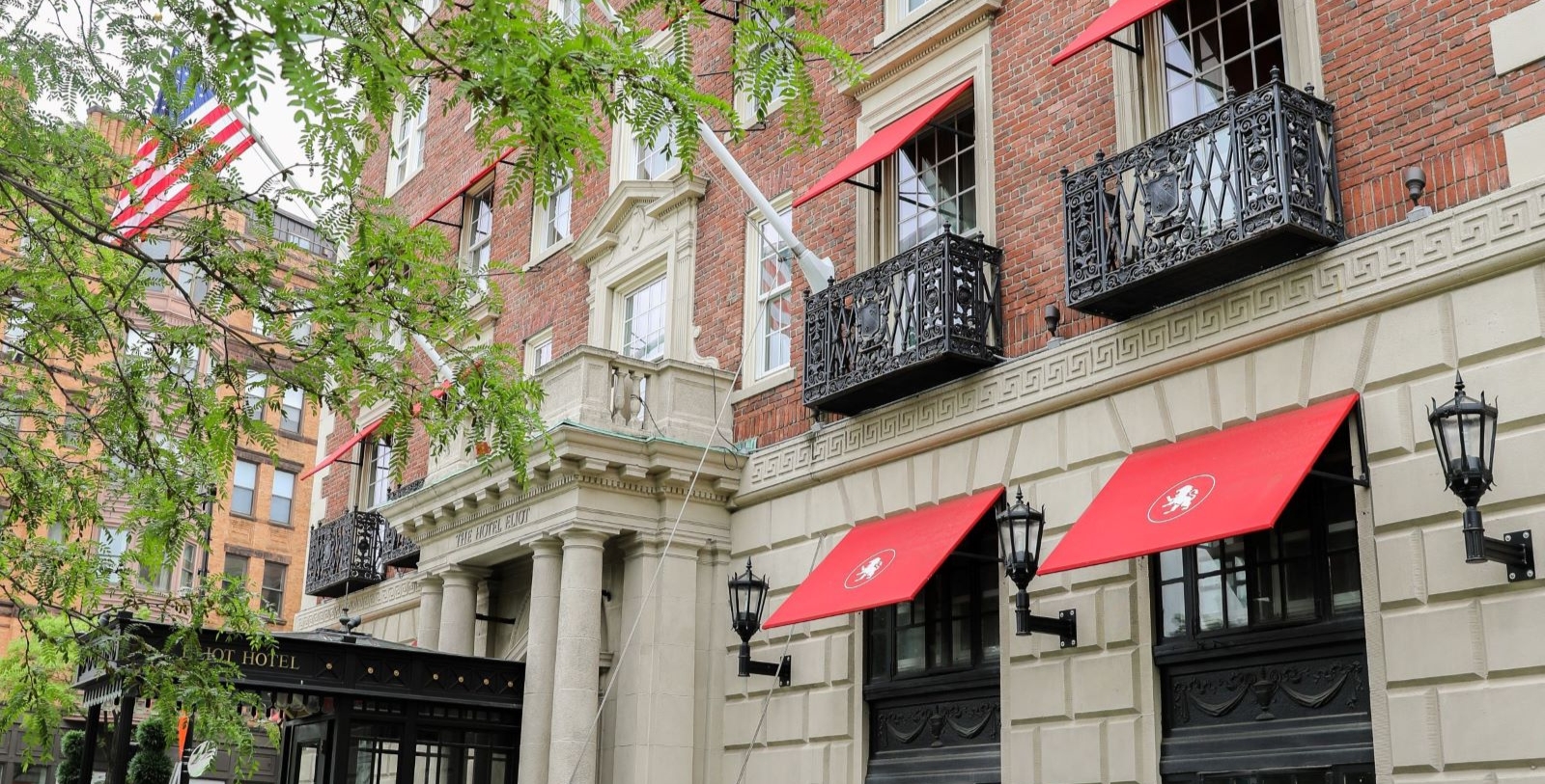 a building with red awnings and black railings