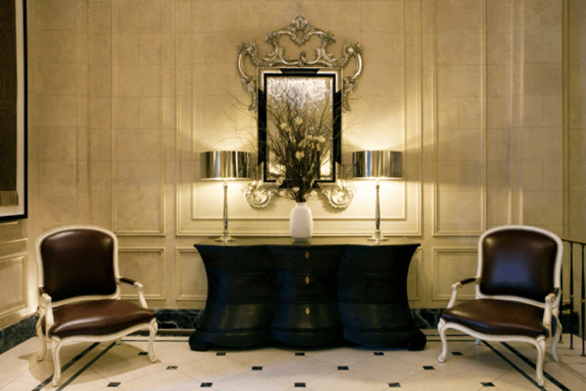 a room with a mirror and a table and chairs