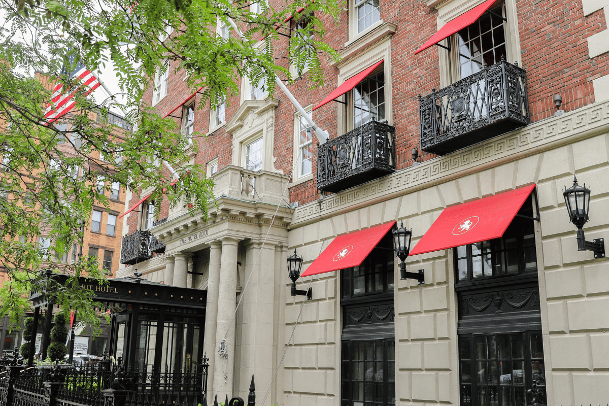 a building with red awnings and black railings