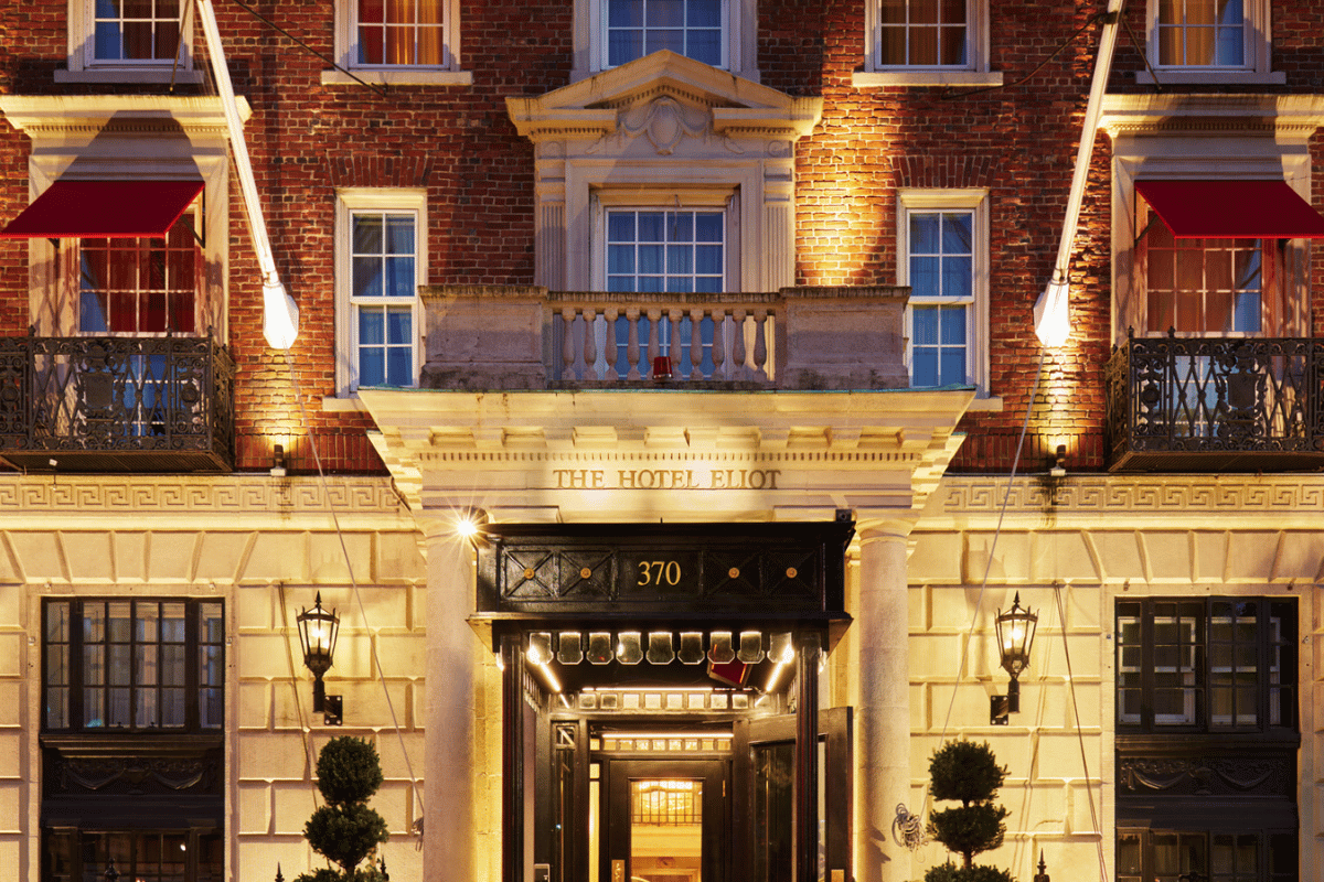 a front of a building with a door and a balcony