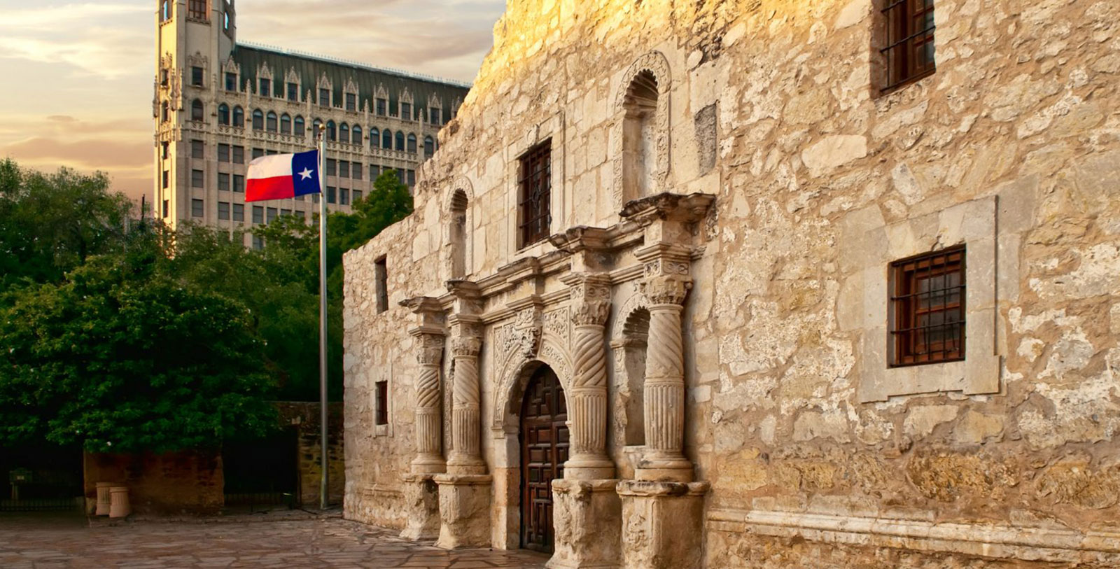 a stone building with a flag in the background