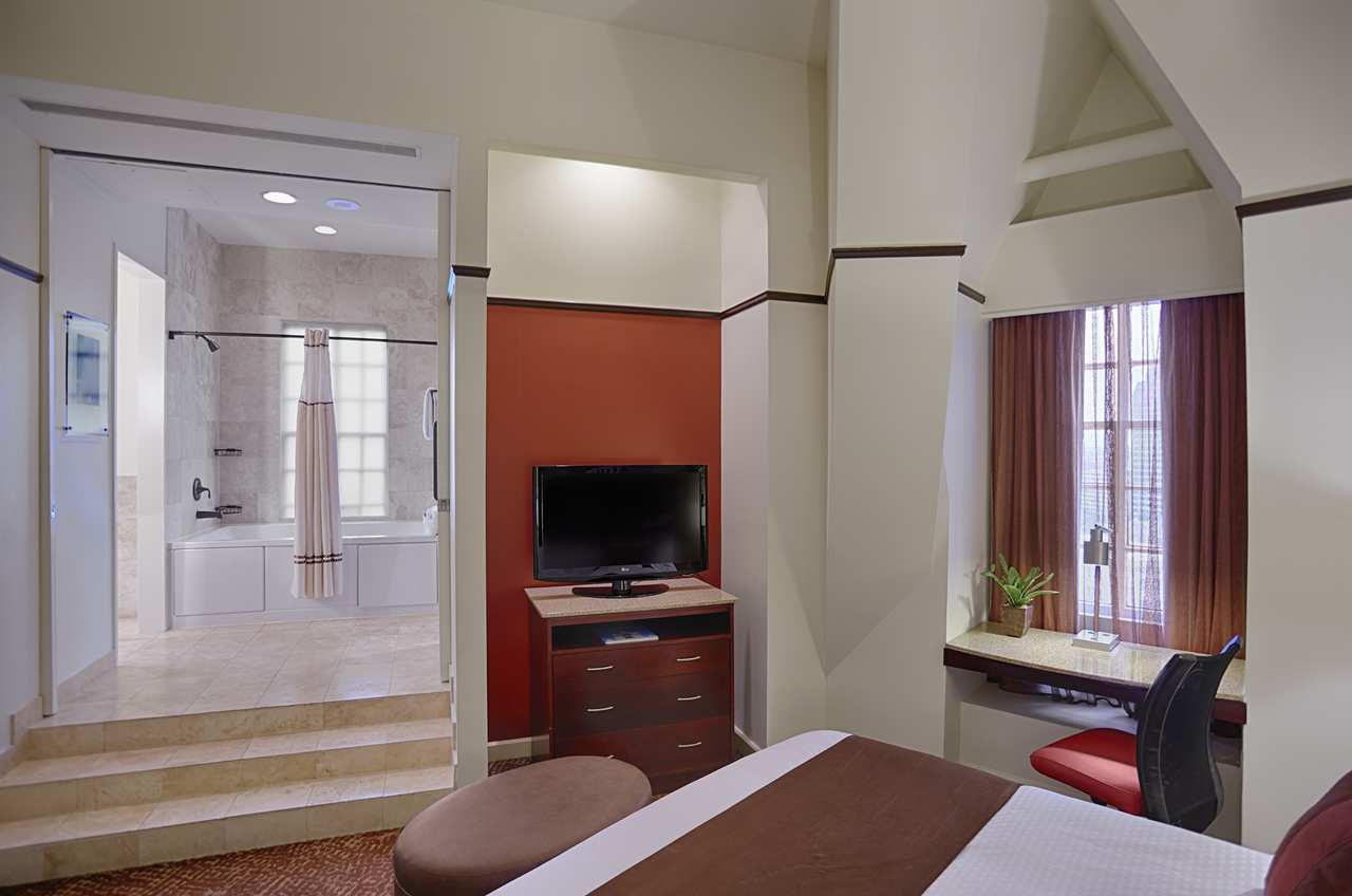 a room with a bed and a television