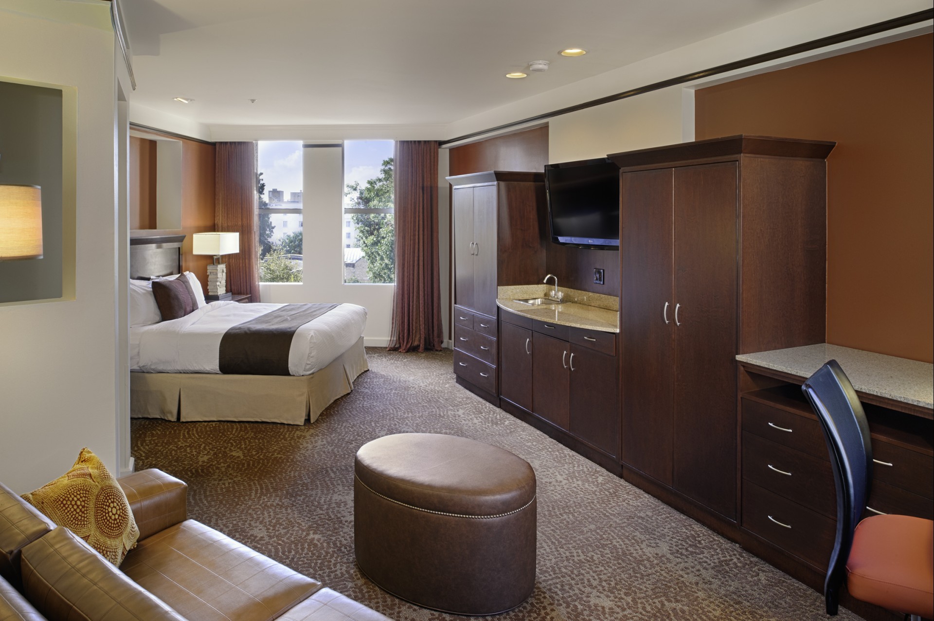 a hotel room with a bed and a television