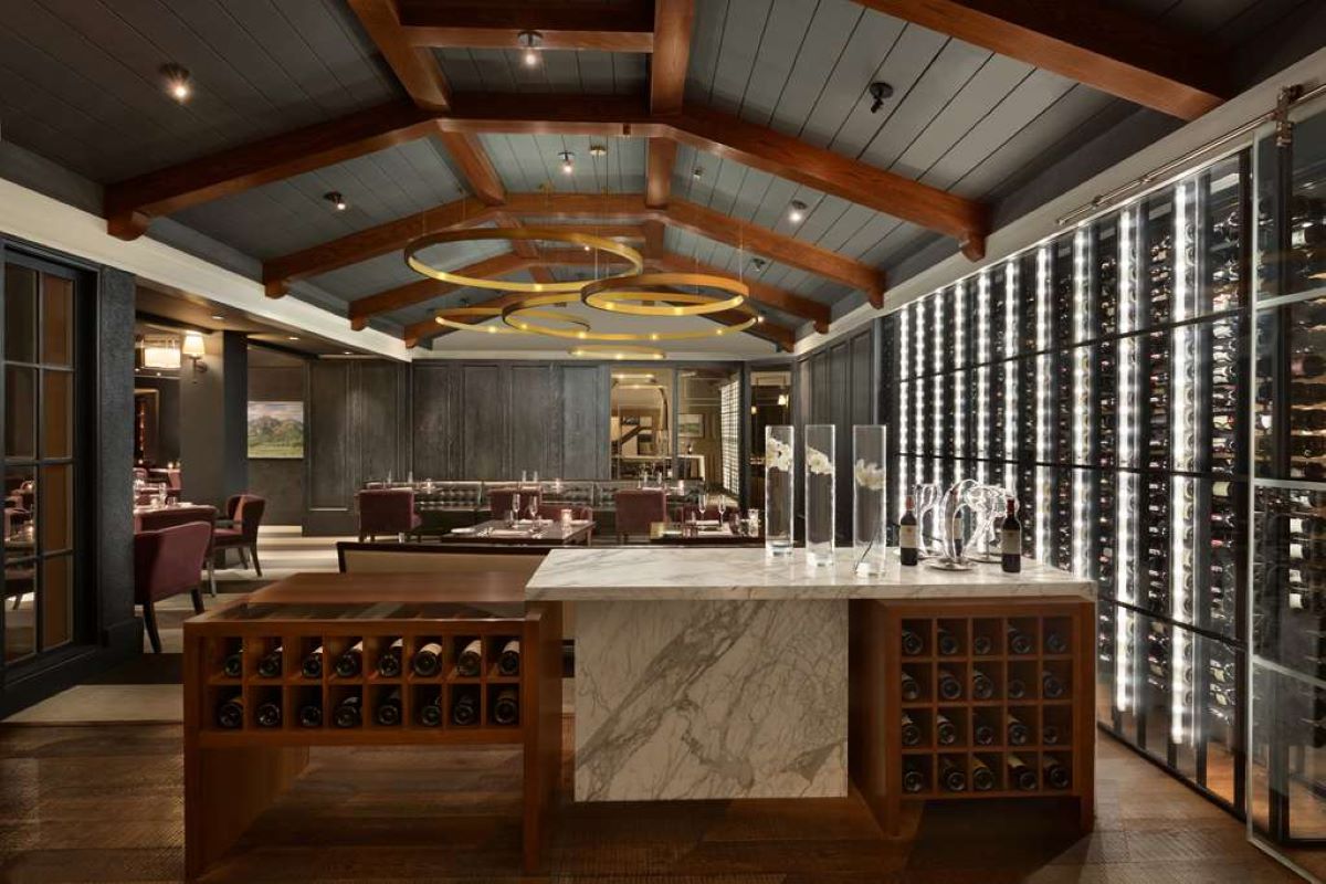 a room with a bar and wine bottles