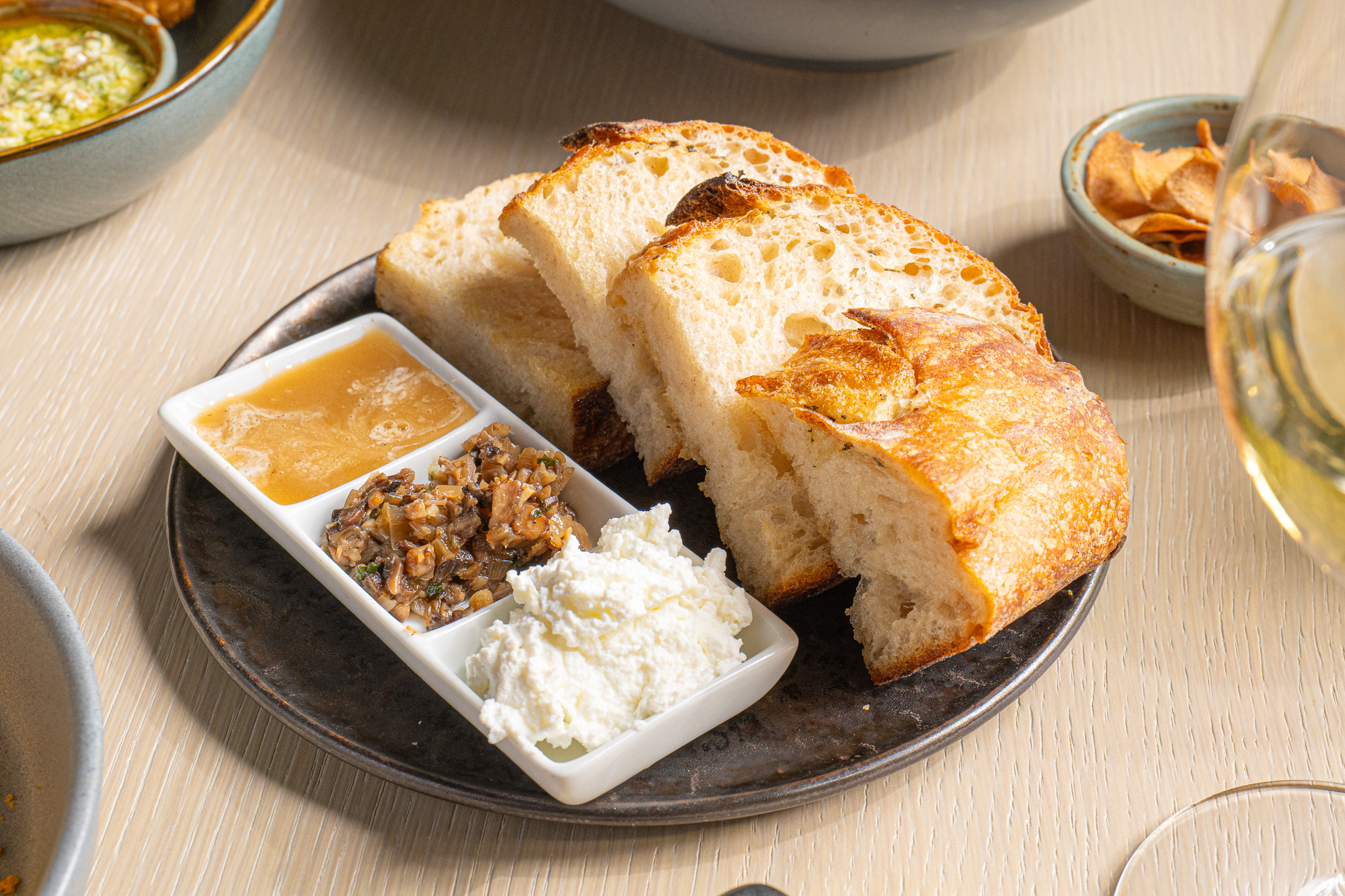 a plate of bread with different dips