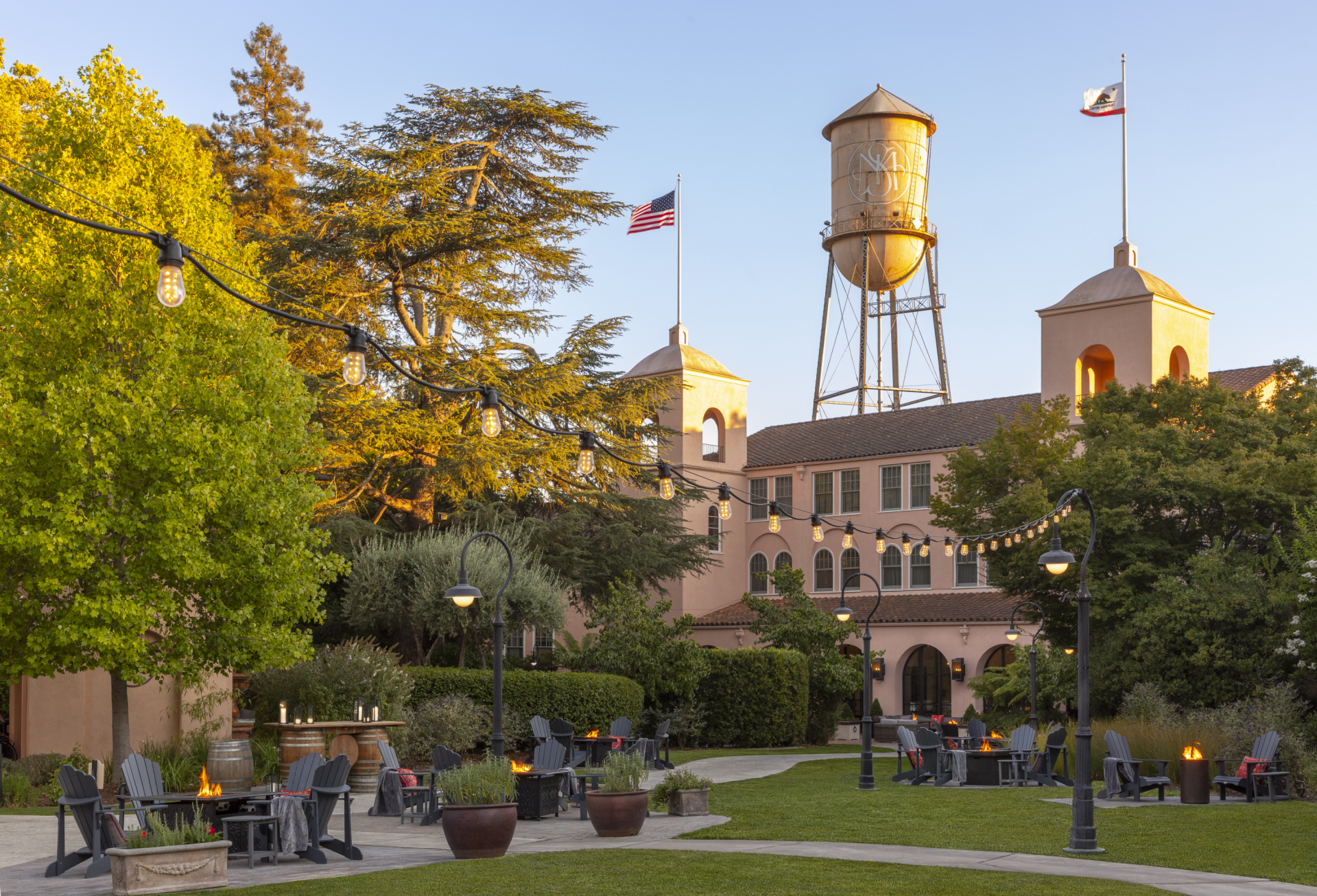 a courtyard with a water tower and chairs