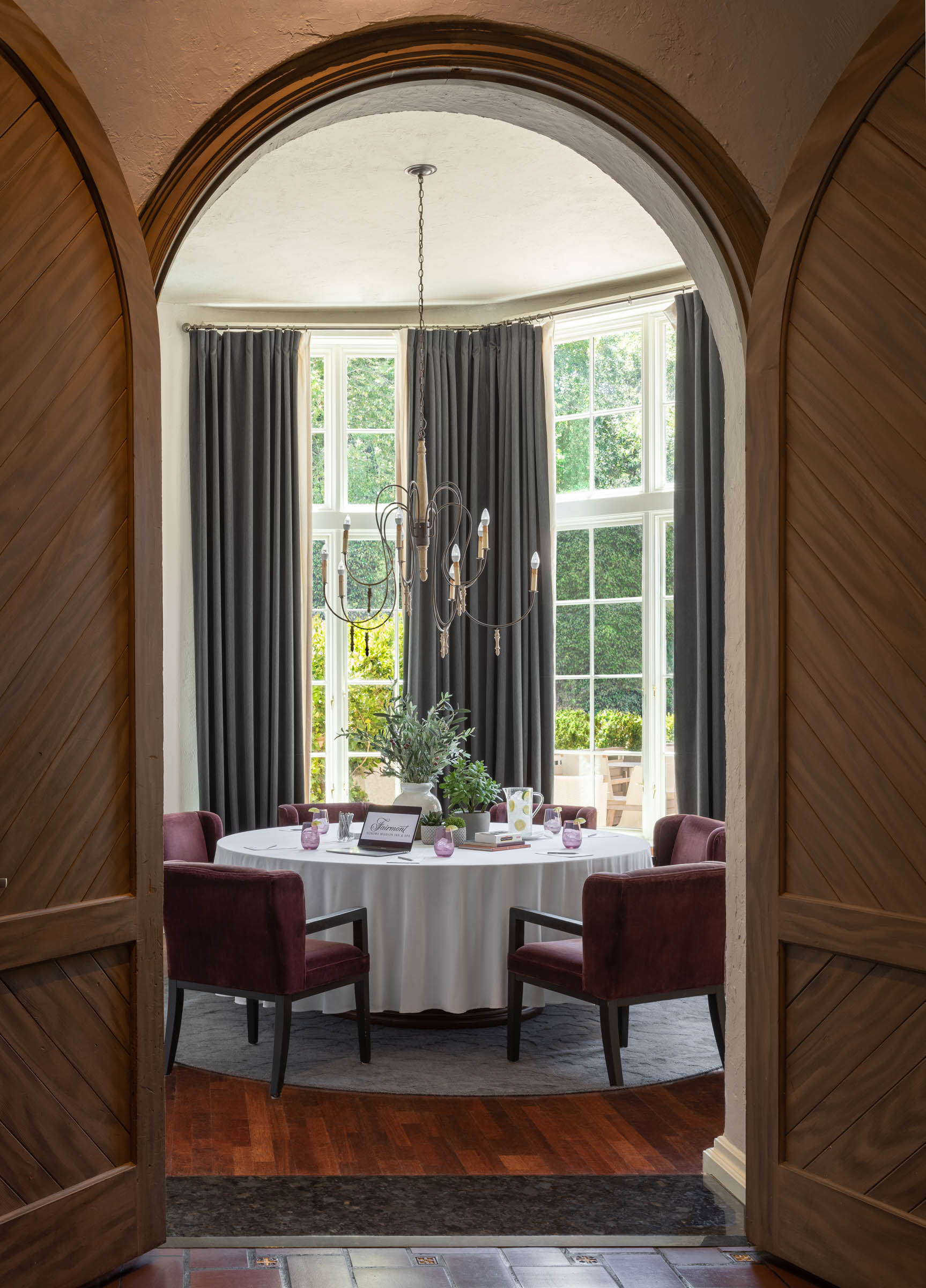 a room with a round table and chairs
