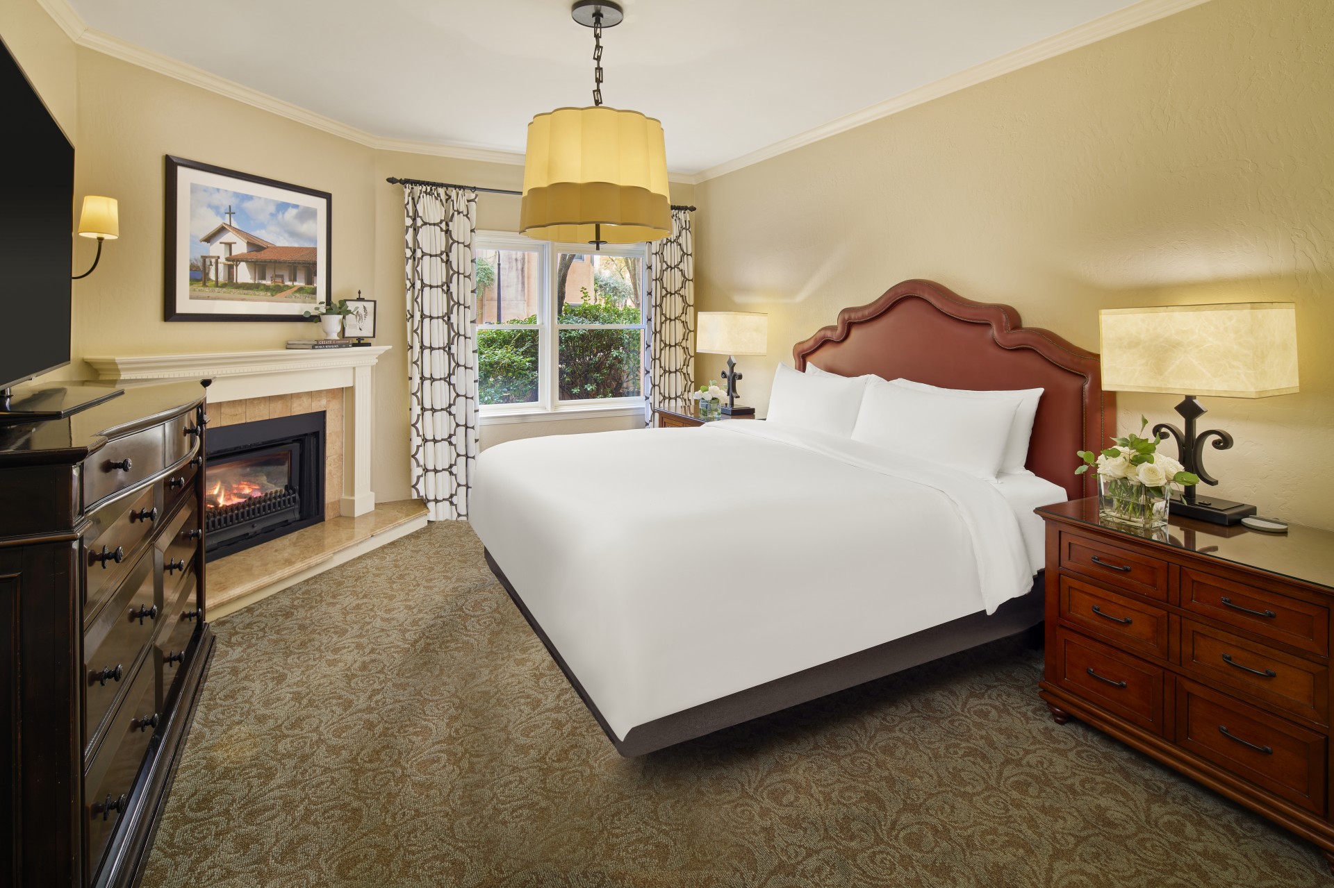 a bedroom with a fireplace and a bed