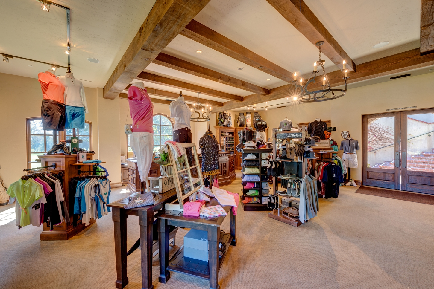a store with clothes and a chandelier