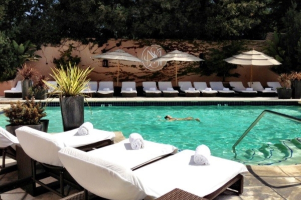 a pool with lounge chairs and umbrellas