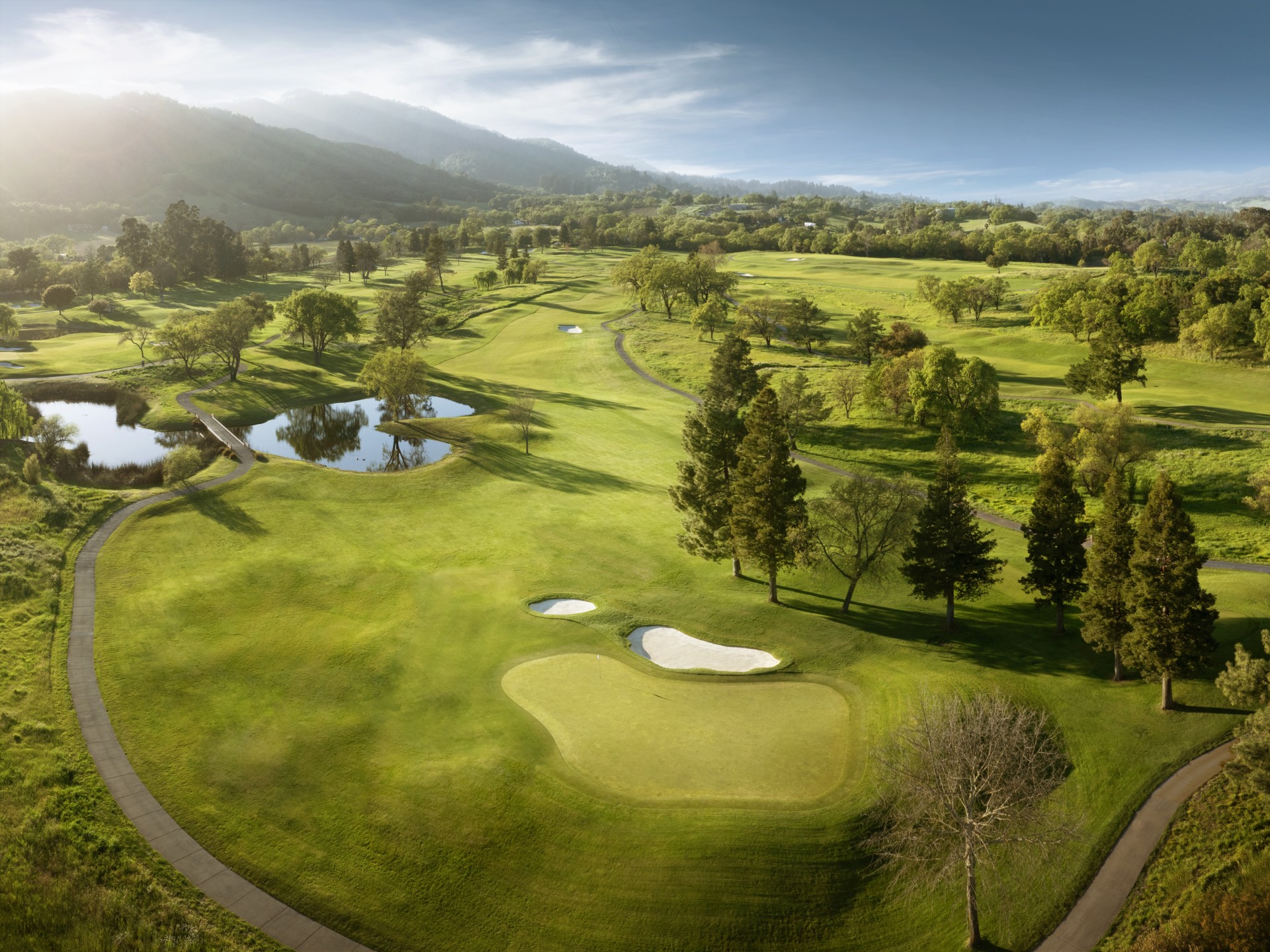 a golf course with water in the middle
