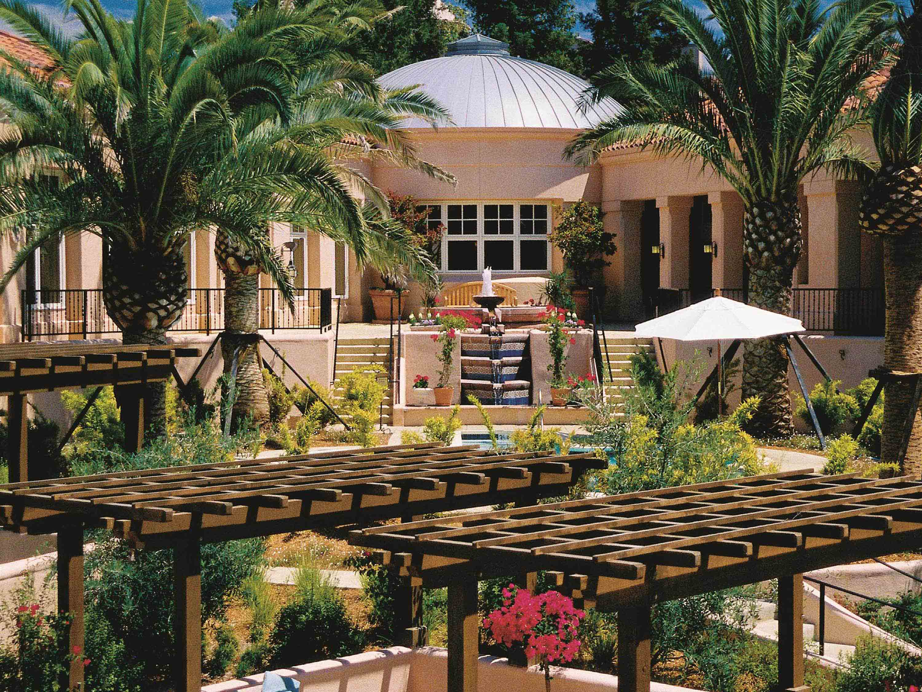 a building with a pool and palm trees
