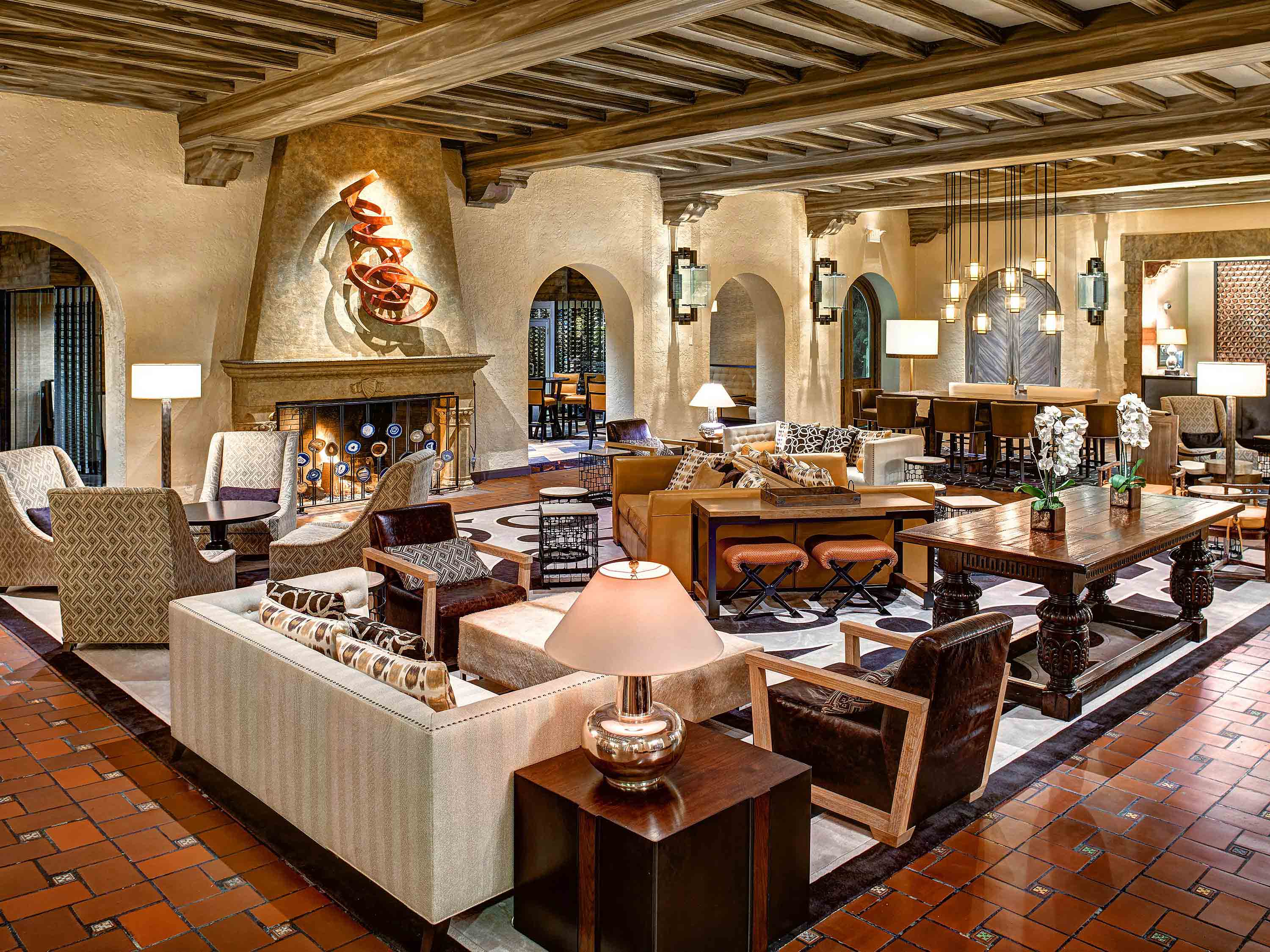 a large room with a fireplace and tables