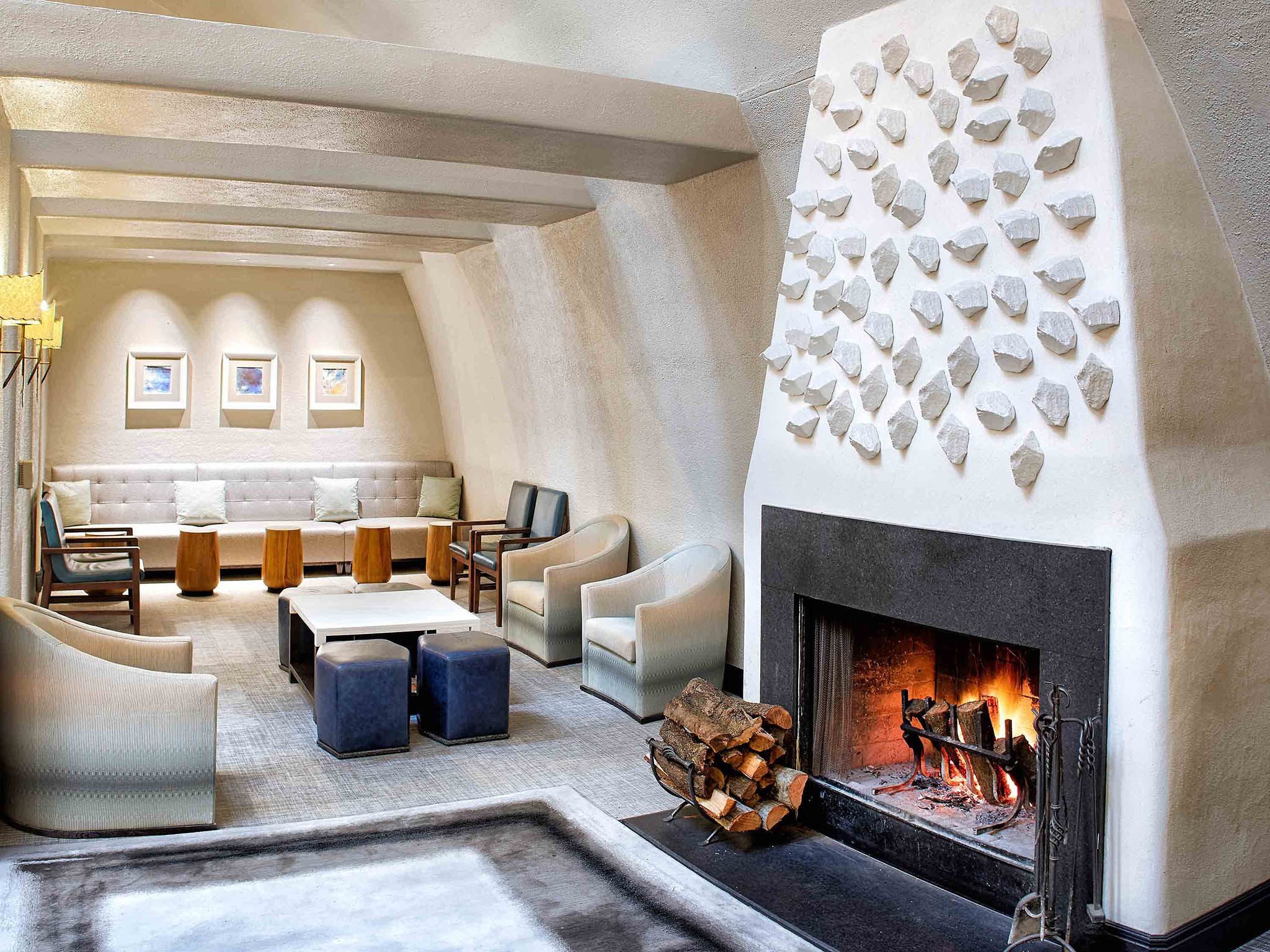 a room with a fireplace and chairs